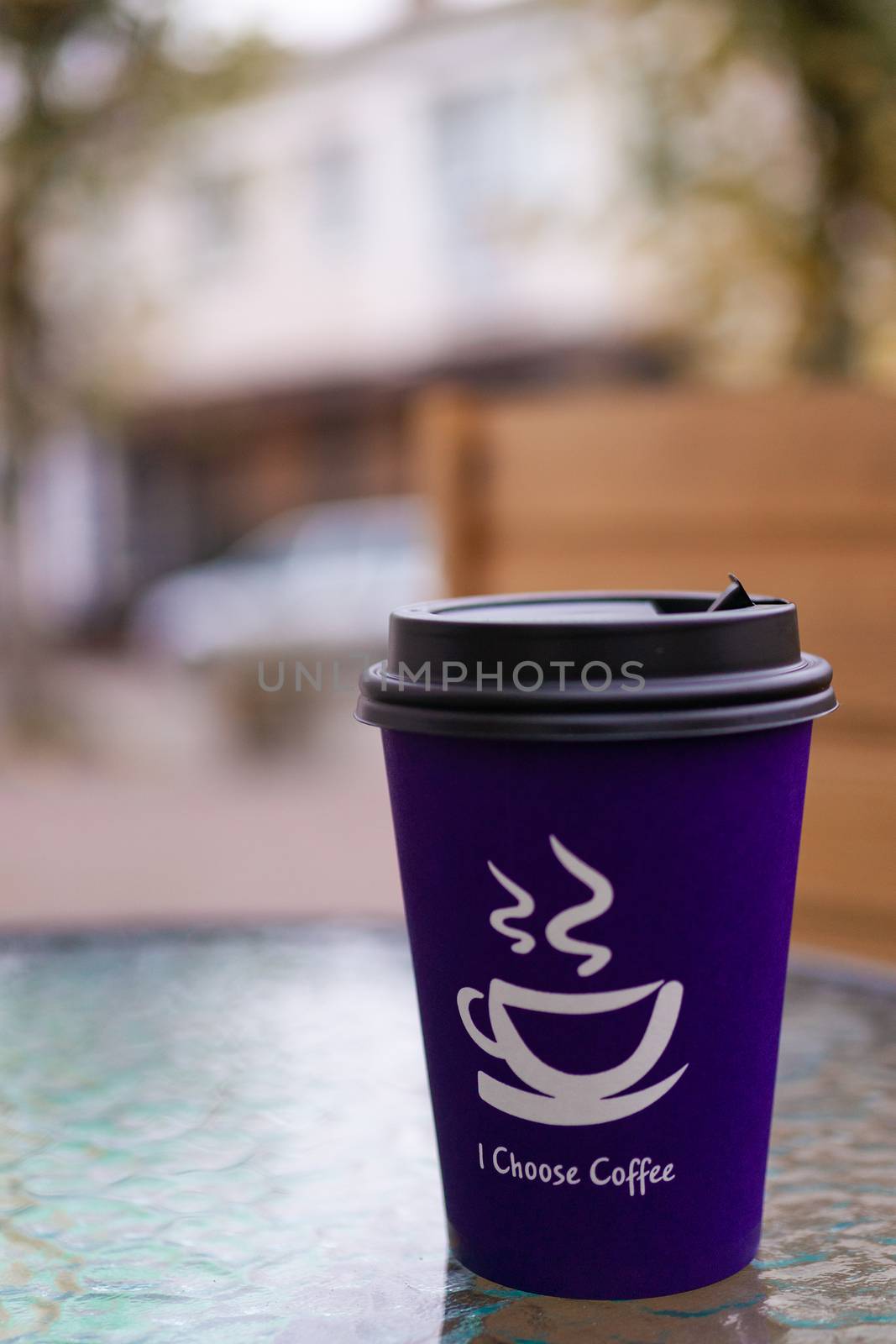 Purple coffee paper cup on glass clear table. On cup wrote: "I choose coffee". Beginning a good day! by alexsdriver
