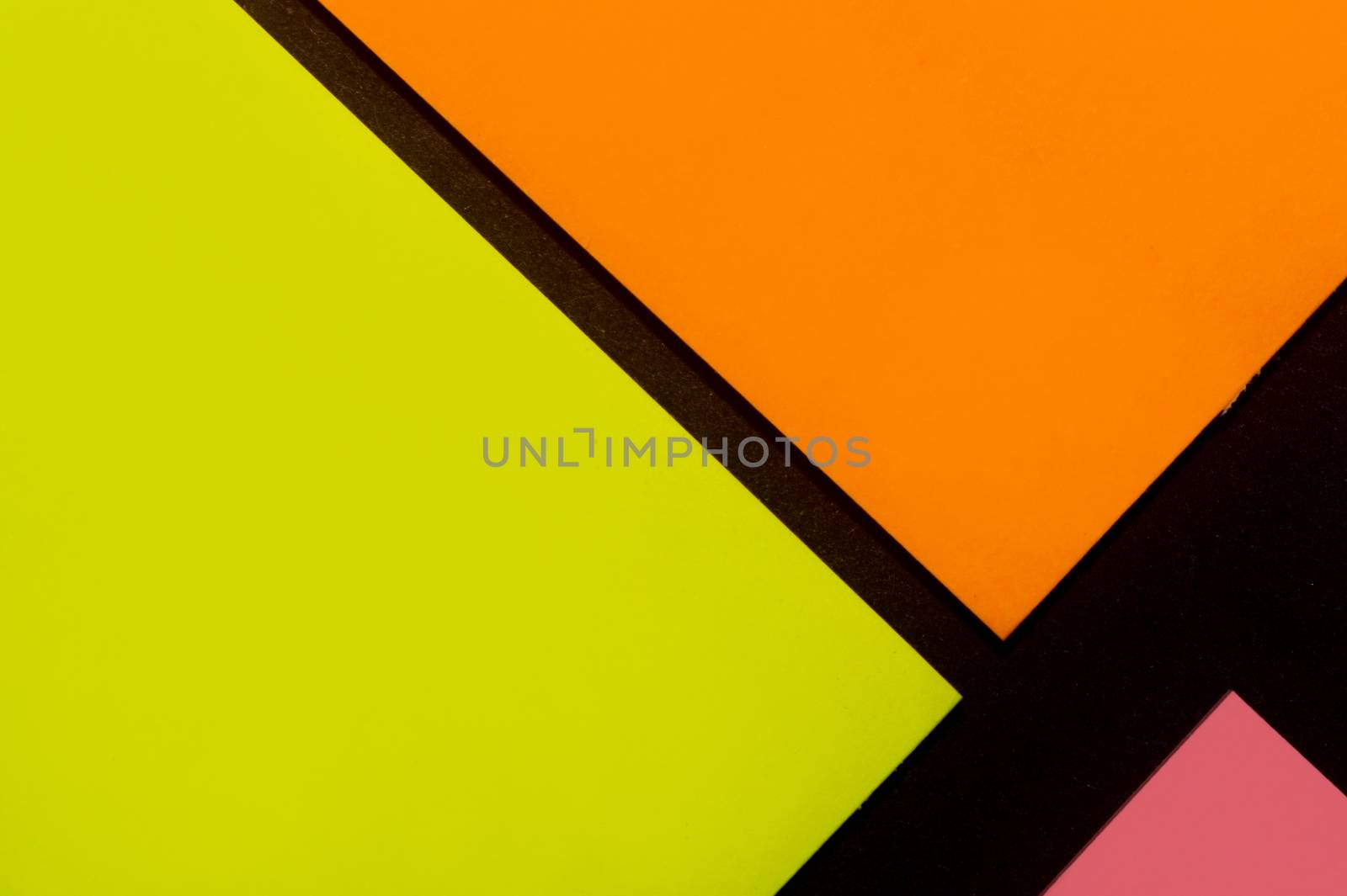 Yellow, orange and rose hue colorful office stickers on black paper. Office noteparer as reminder. Isolated on black paper.