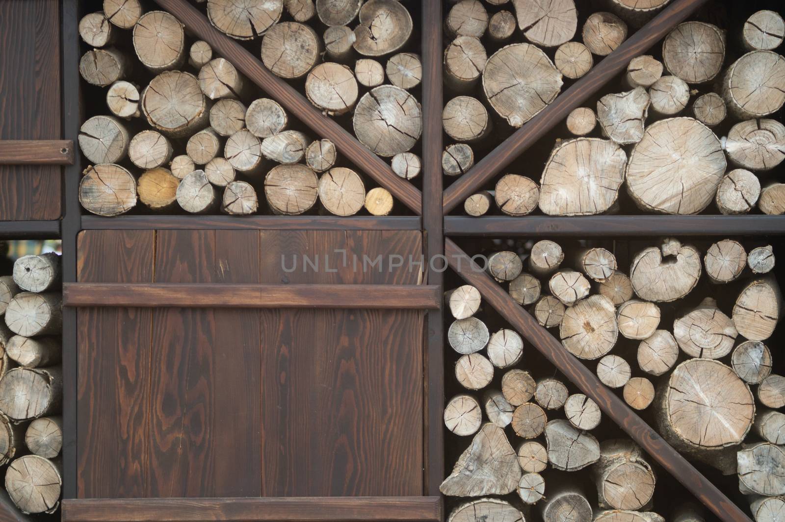 Wooden logs stacked near the cafe wall. Decorative and beautiful item.