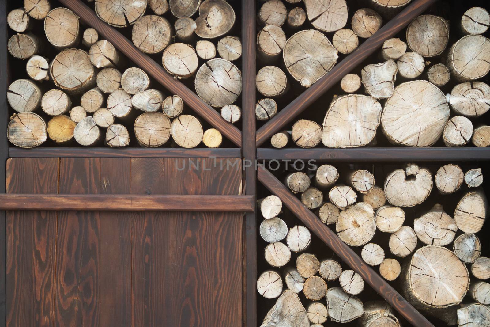 Wooden logs stacked near the cafe wall. Decorative and beautiful item.
