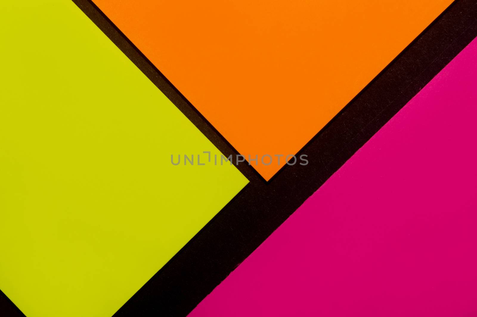 Purple, yellow and orange hue colorful office stickers on black paper. Office noteparer as reminder. Isolated on black paper.