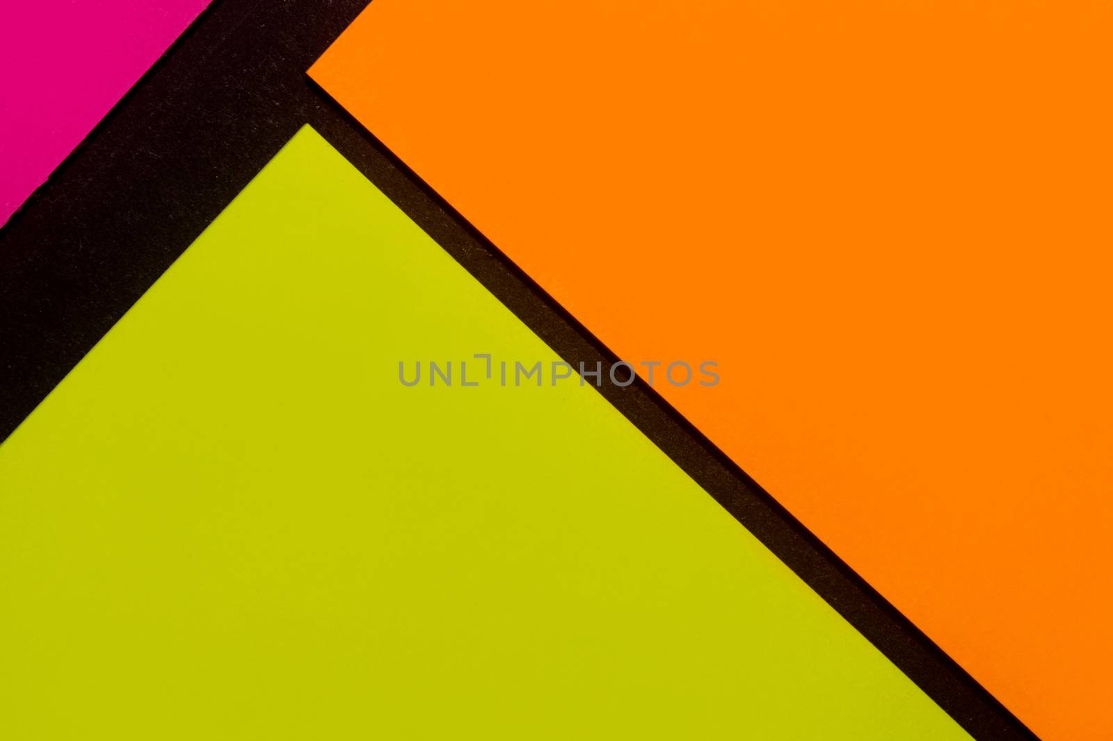 Purple, yellow and orange hue colorful office stickers on black paper. Office noteparer as reminder. Isolated on black paper.