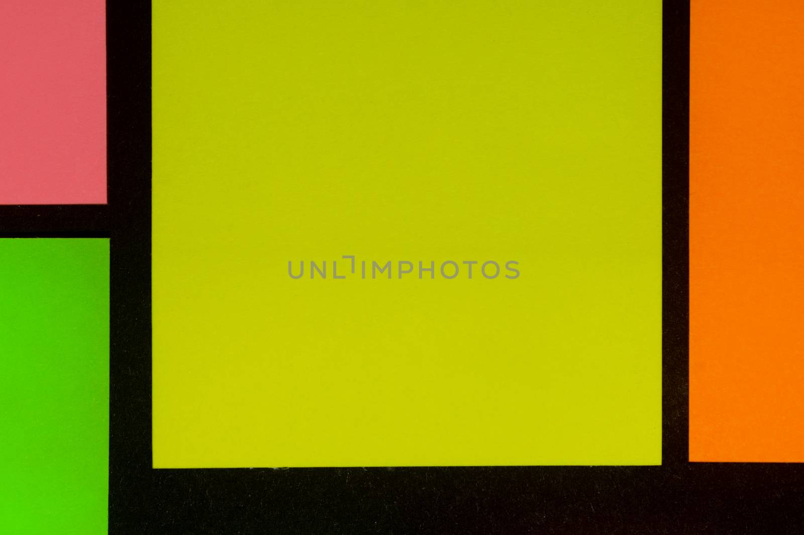 Green, yellow, orange and rose hue colorful office stickers on black paper. Office noteparer as reminder. Isolated on black paper.