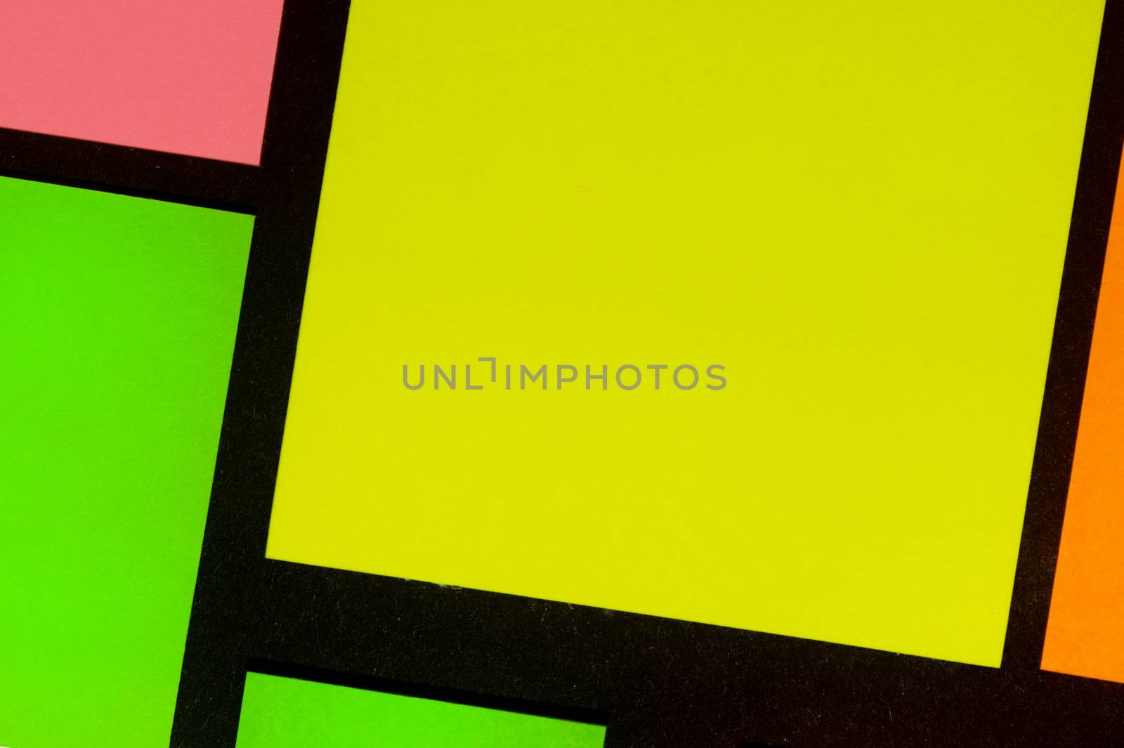 Green, yellow, orange and rose hue colorful office stickers on black paper. Office noteparer as reminder. Isolated on black paper.