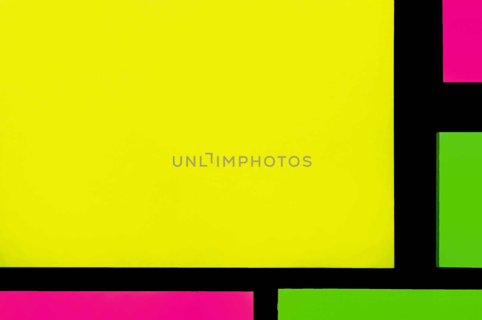 Green, yellow and purple hue colorful office stickers on black paper. Office noteparer as reminder. Isolated on black paper.