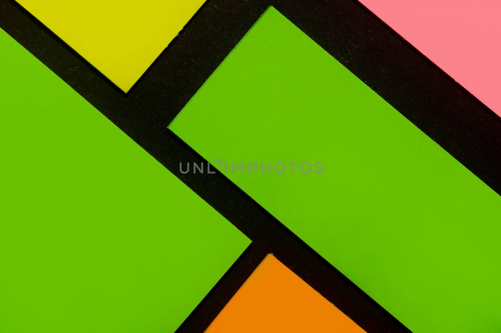 Green, yellow, orange and rose hue colorful office stickers on black paper. Office noteparer as reminder. Isolated on black paper.