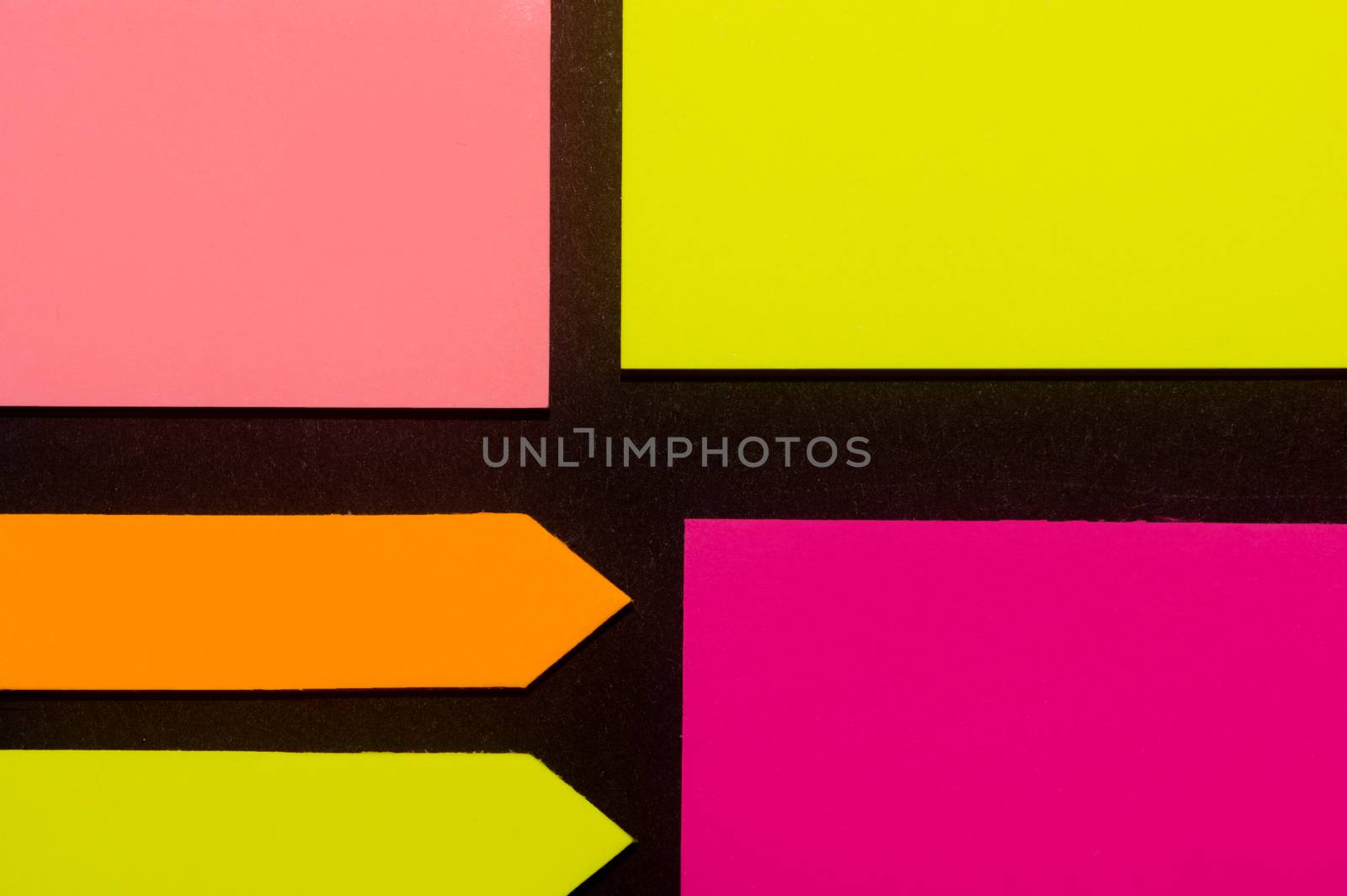 Purple, yellow, orange and rose hue colorful office stickers on black paper. Office noteparer as reminder. Isolated on black paper.