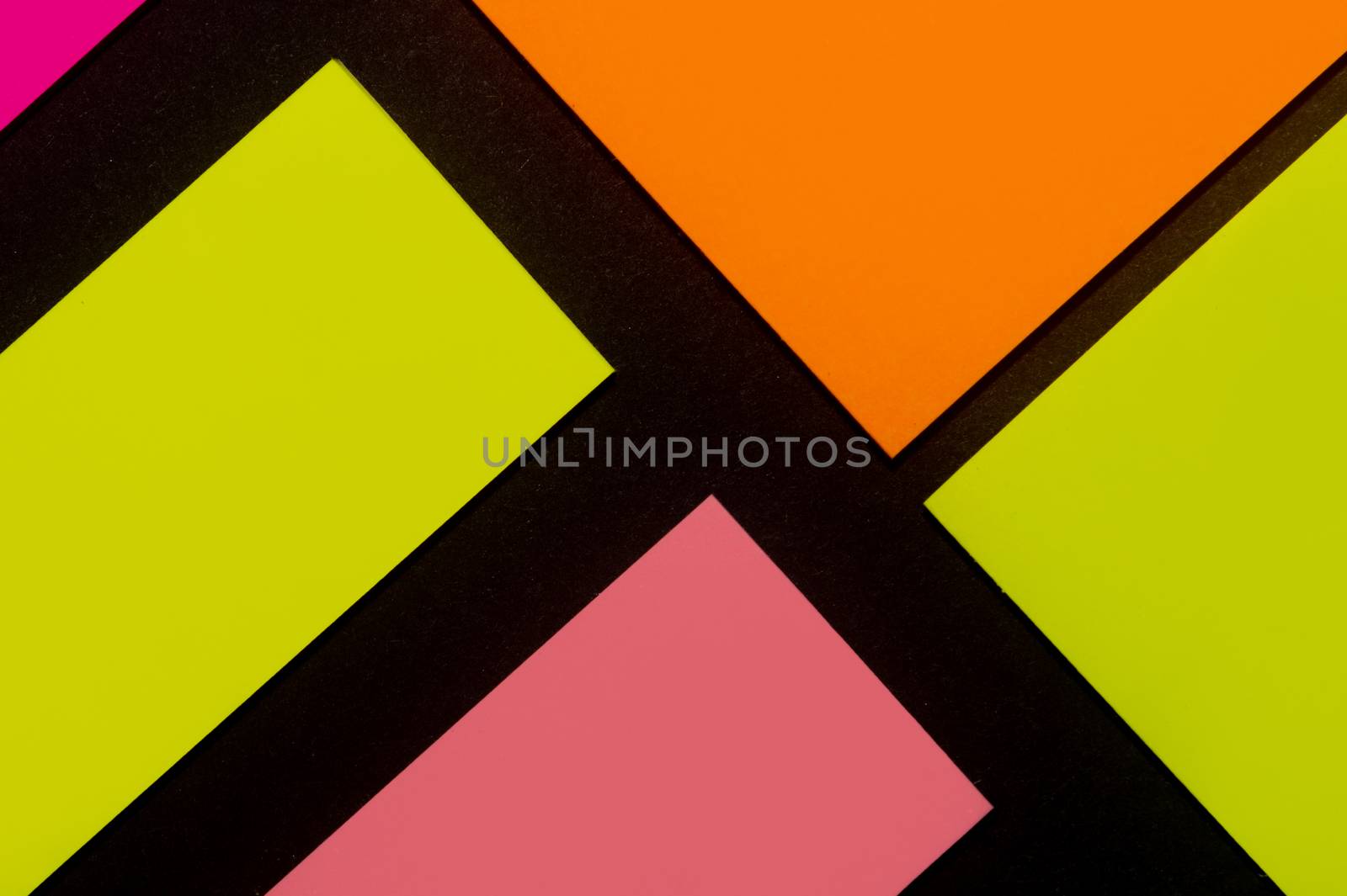 Purple, yellow, orange and rose hue colorful office stickers on black paper. Office noteparer as reminder. Isolated on black paper.