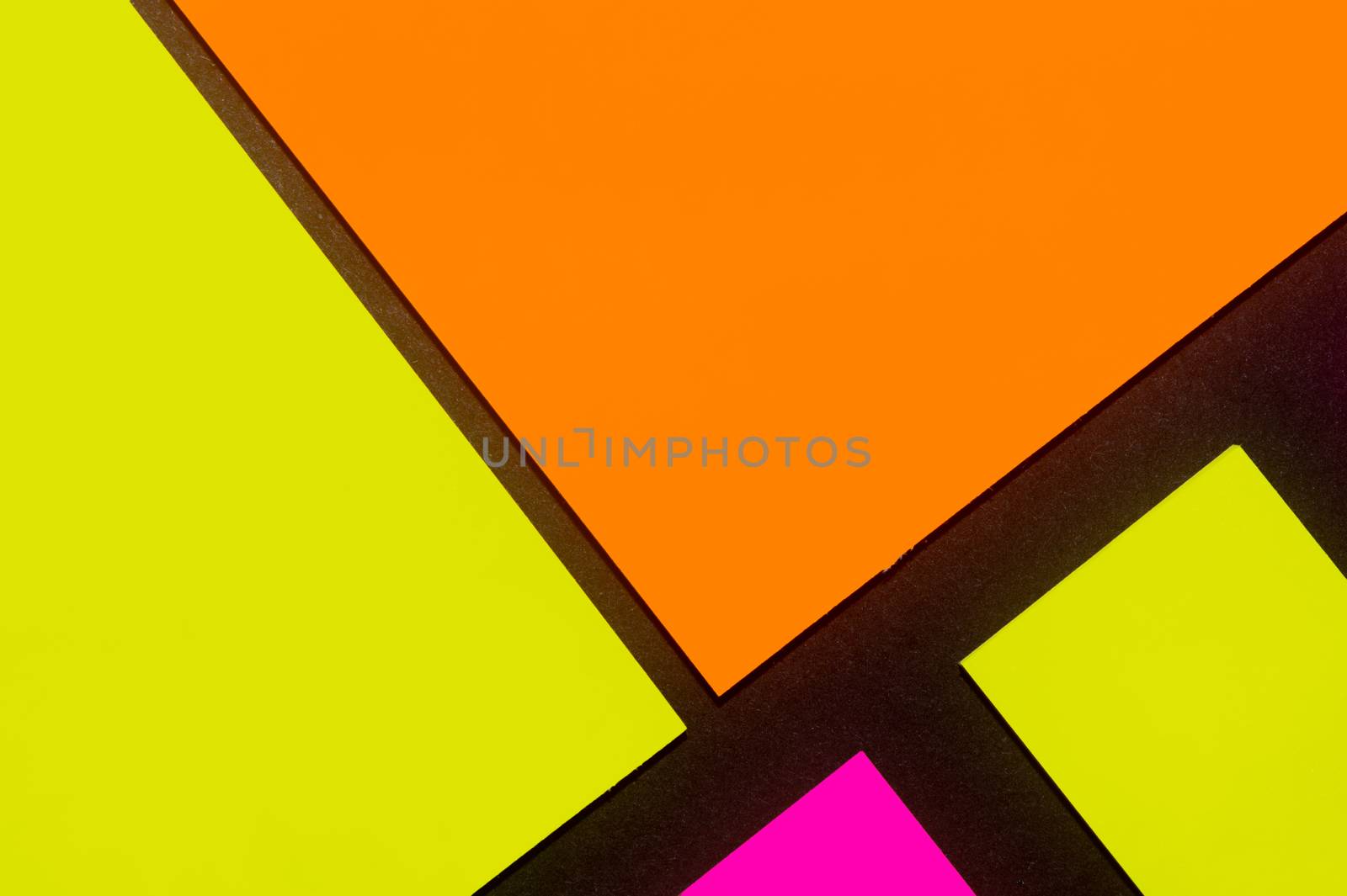 Yellow, orange and purple hue colorful office stickers on black paper. Office noteparer as reminder. Isolated on black paper.