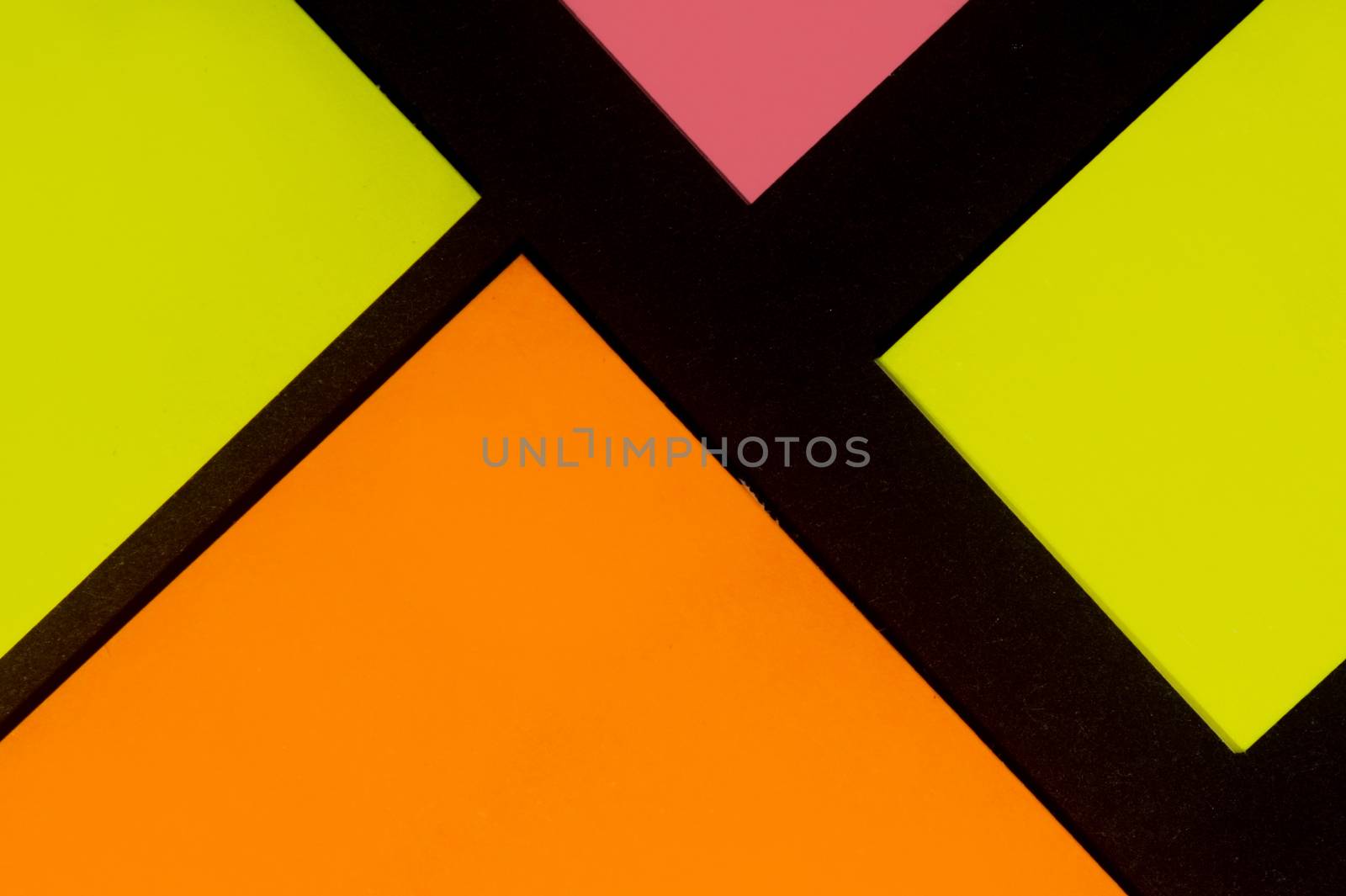 Yellow, orange and rose hue colorful office stickers on black paper. Office noteparer as reminder. Isolated on black paper.