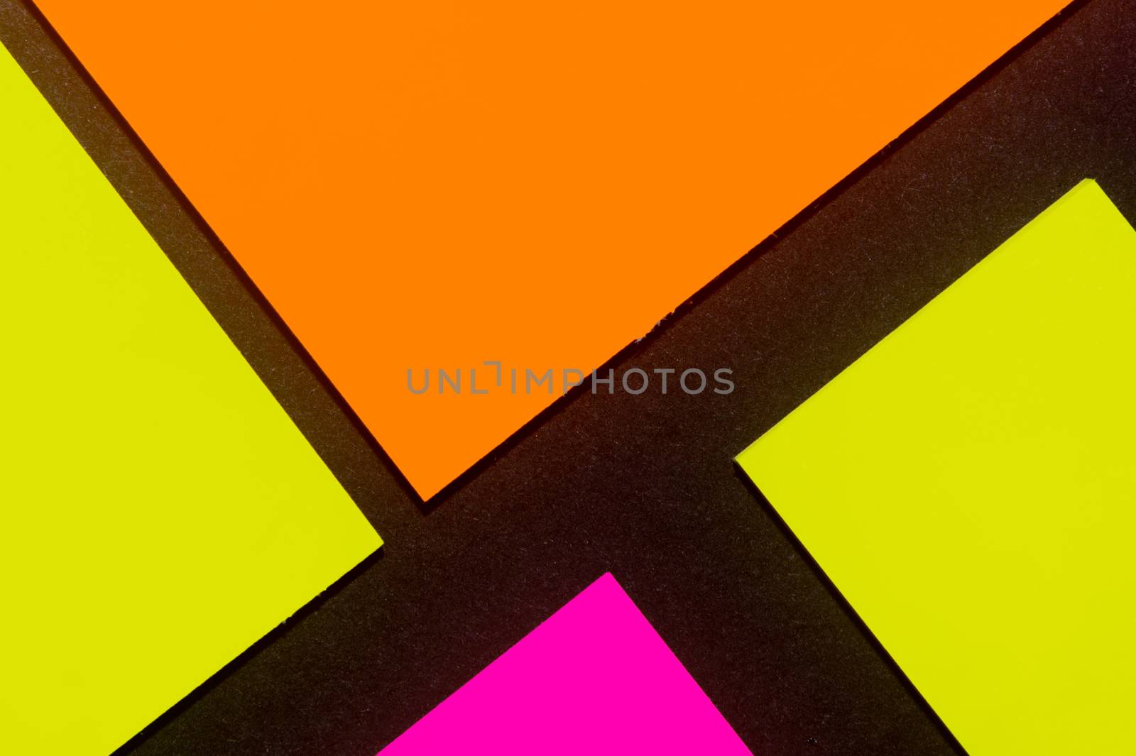 Yellow, orange and purple hue colorful office stickers on black paper. Office noteparer as reminder. Isolated on black paper.