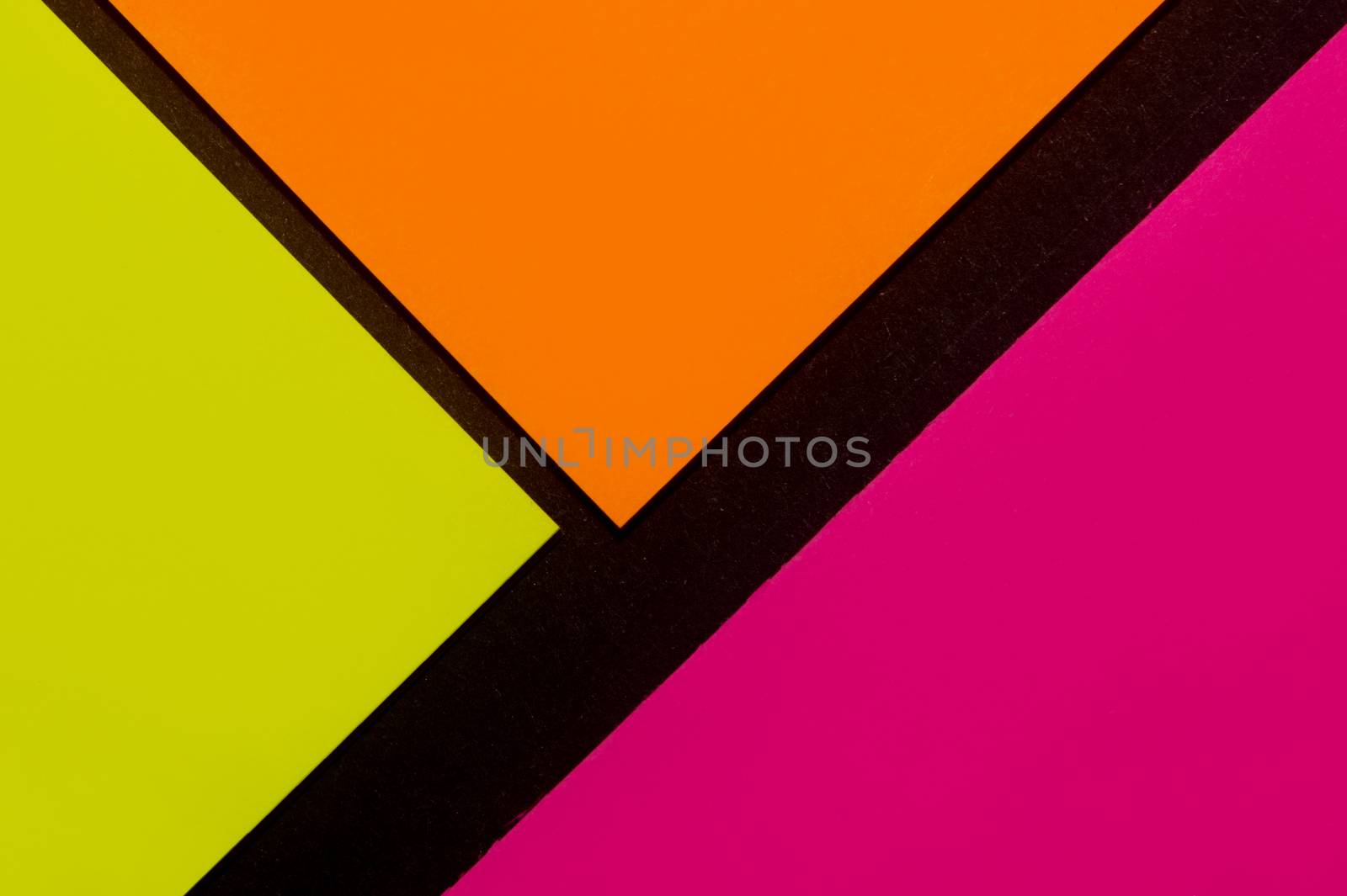 Purple, yellow and orange hue colorful office stickers on black paper. Office noteparer as reminder. Isolated on black paper.
