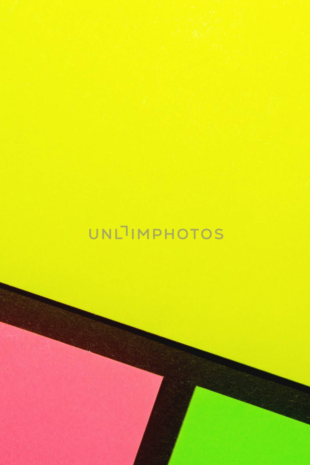 Green, yellow and rose hue colorful office stickers on black paper. Office noteparer as reminder. Isolated on black paper.