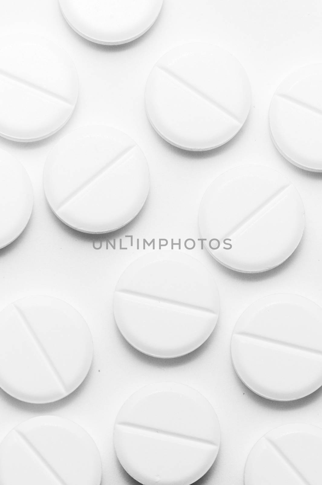 White pills on white background. Close-up view. Medical background. Healthcare image.