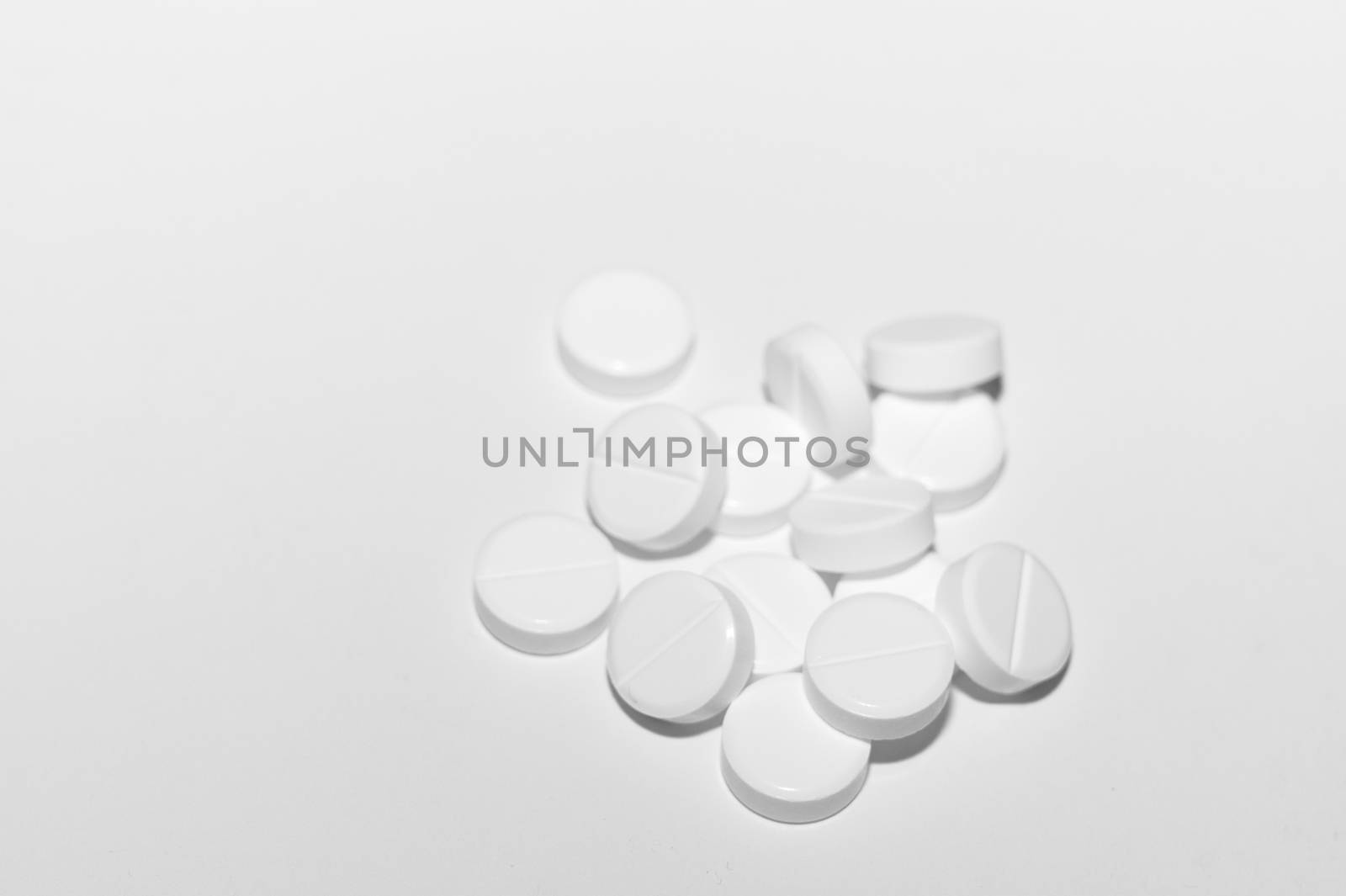 White pills on white background. Close-up view. Medical background. Healthcare image.