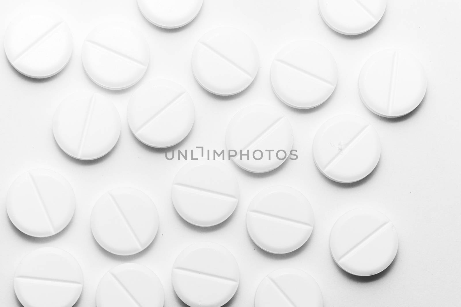 White pills on white background. Close-up view. Medical background. Healthcare image.