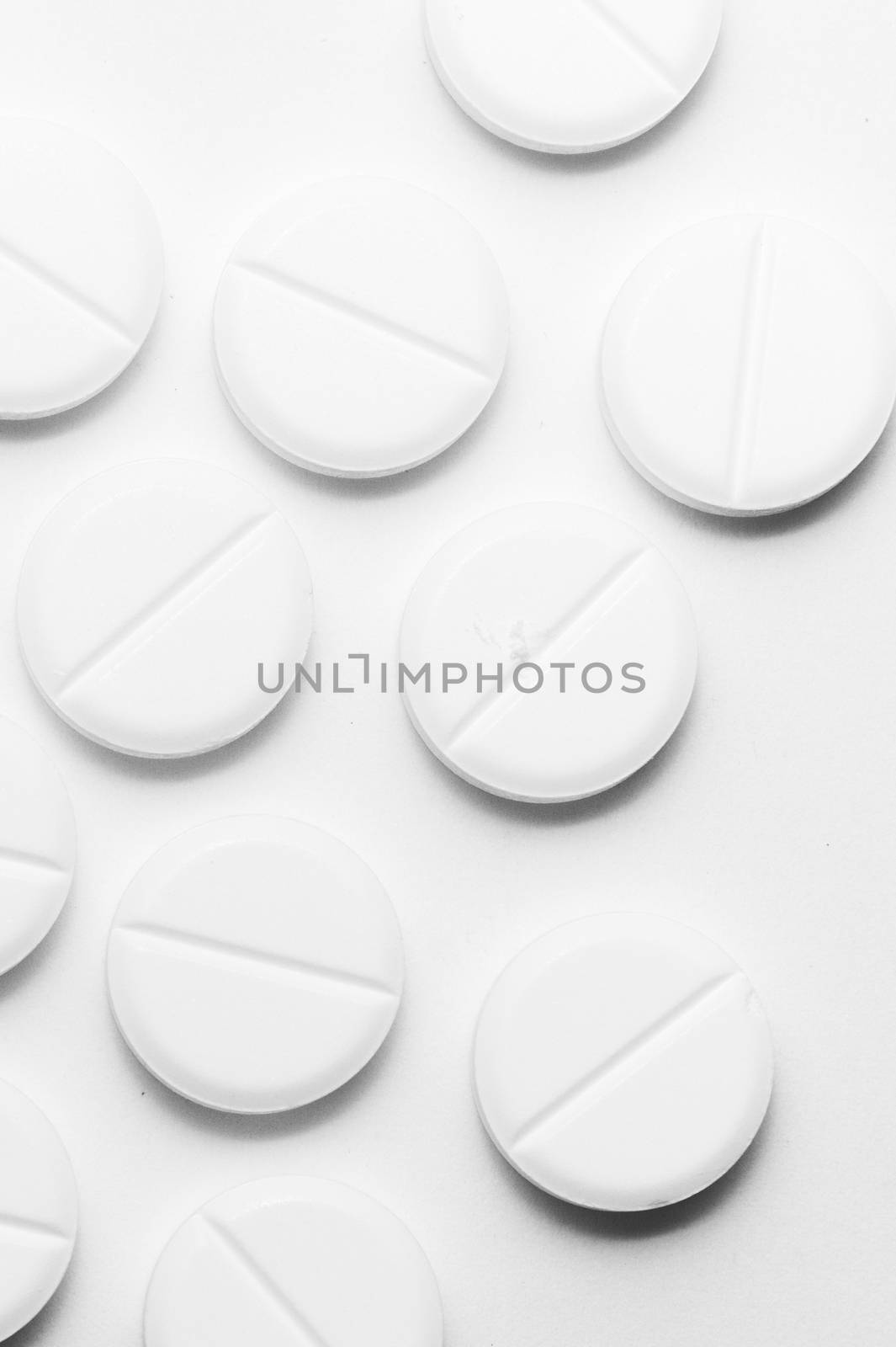 White pills on white background. Close-up view. Medical background. Healthcare image.