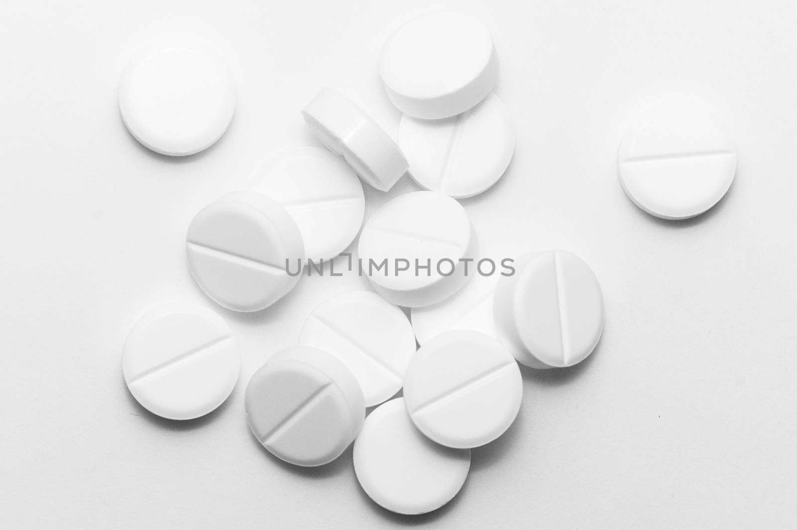 White pills on white background. Close-up view. Medical background. Healthcare image. by alexsdriver