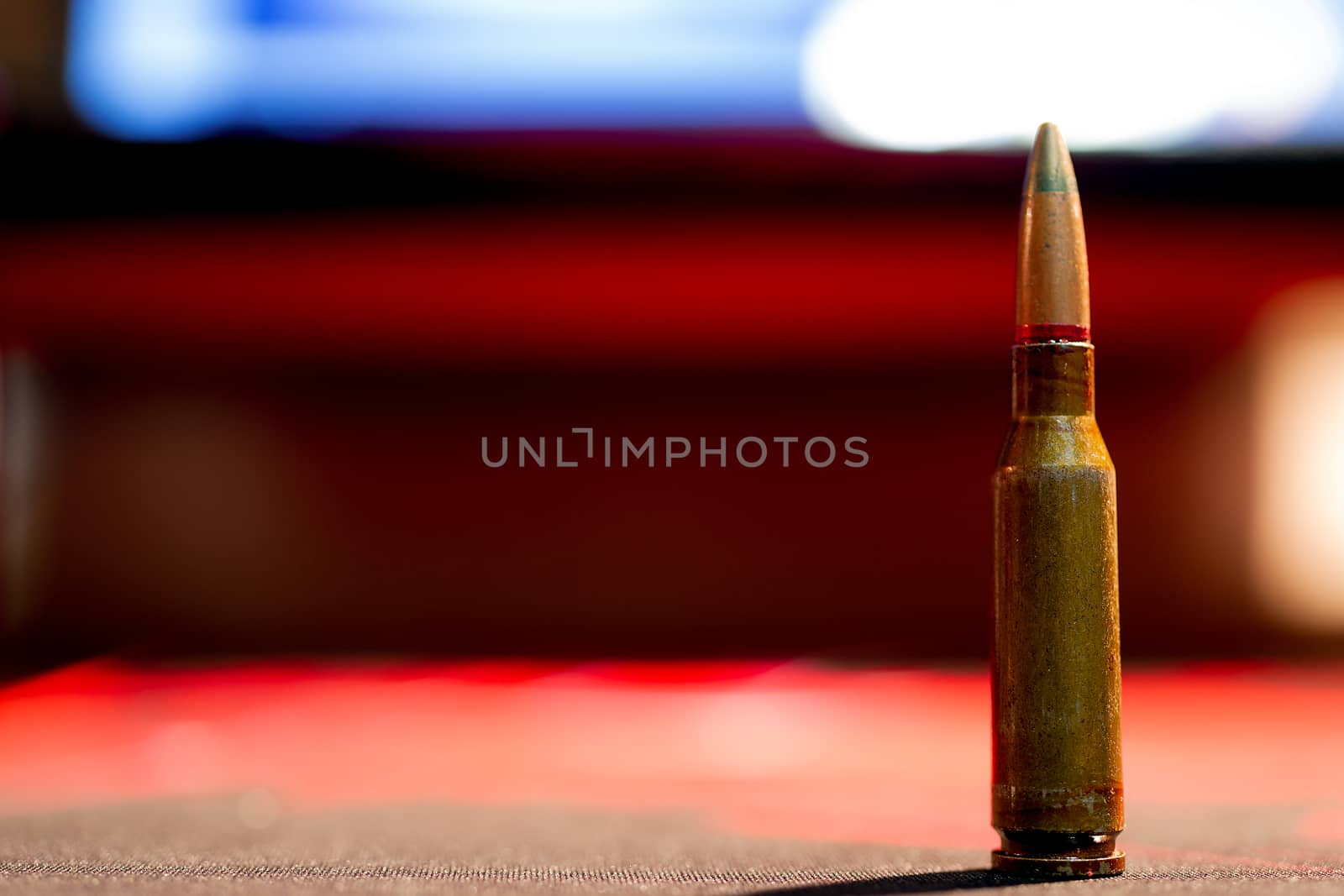 Rifle AK-47 ammo bullet close-up on blurred background. Armor piercing cartridge.