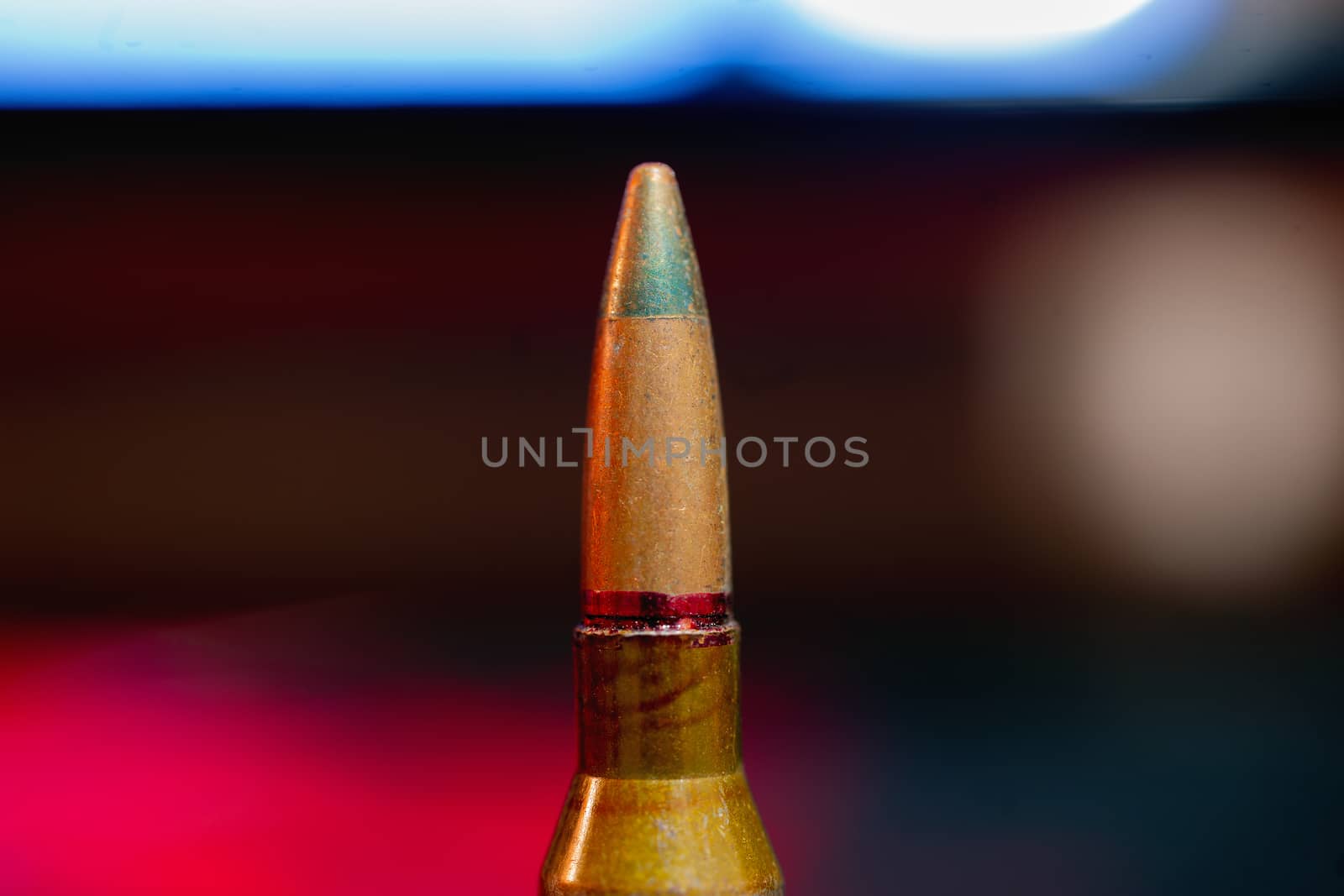 Rifle AK-47 ammo bullet close-up on blurred background. Armor piercing cartridge.