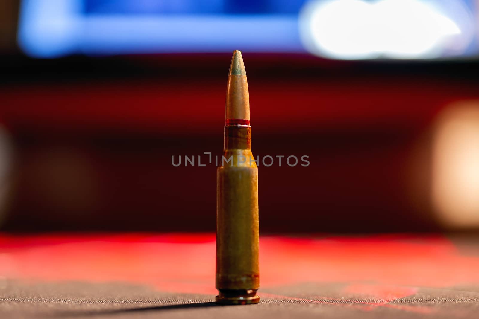 Rifle AK-47 ammo bullet close-up on blurred background. Armor piercing cartridge. by alexsdriver