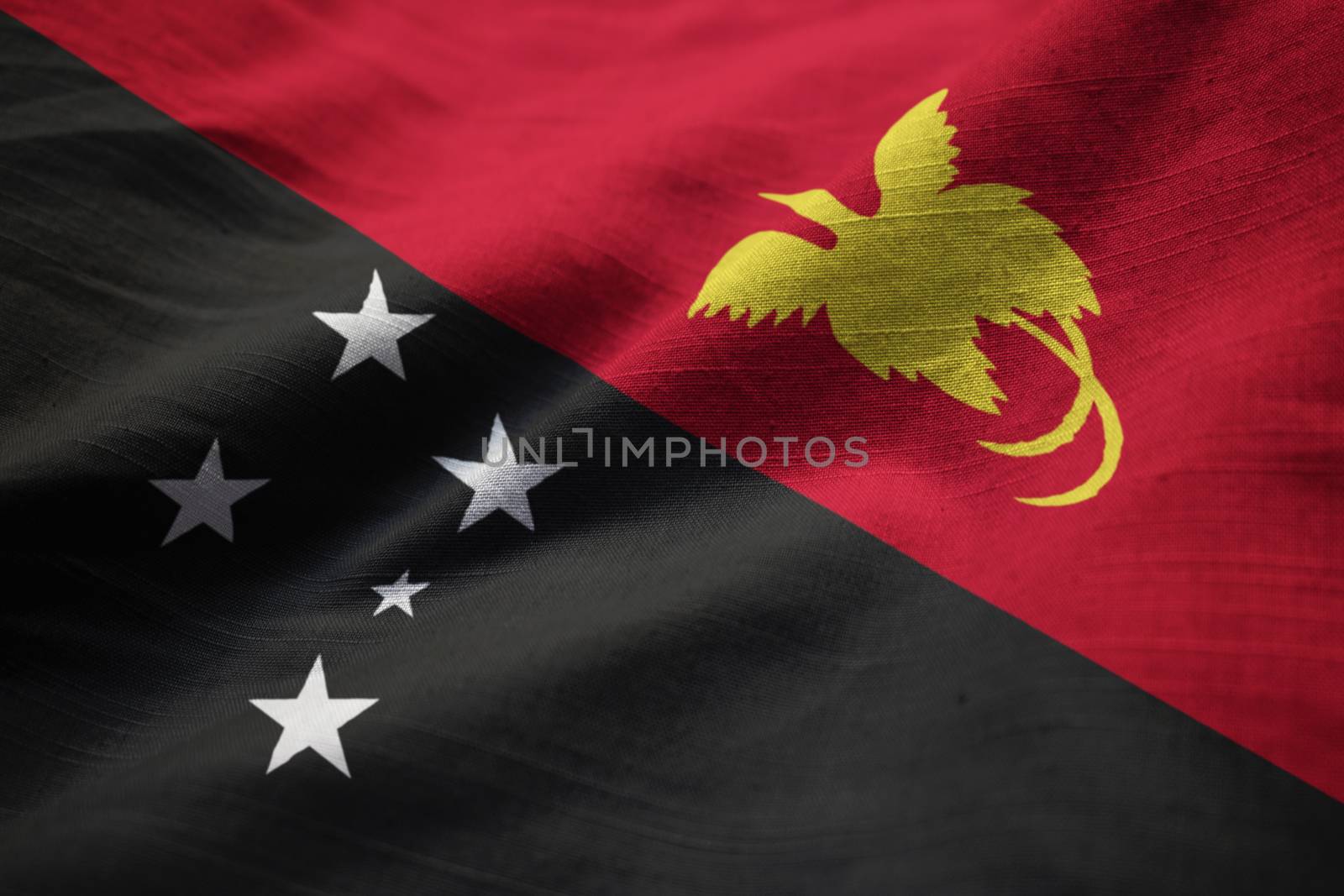 Closeup of Ruffled Papua New Guinea Flag, Papua New Guinea Flag Blowing in Wind