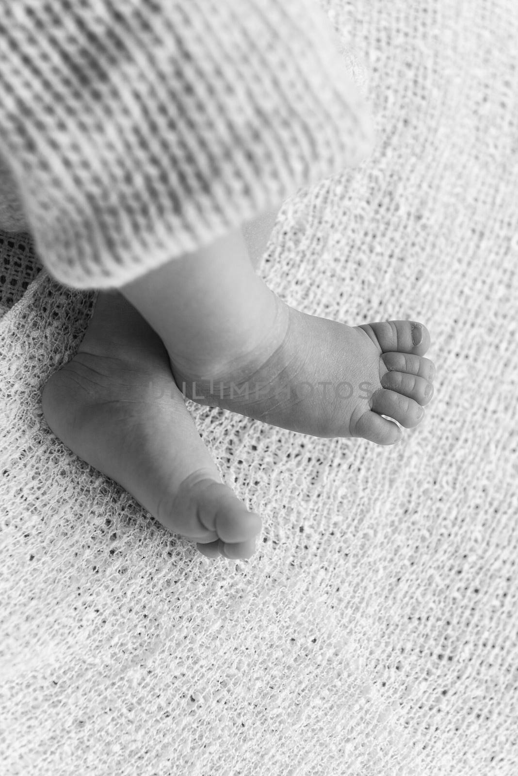 Closeup of a newborn baby feet by marcorubino