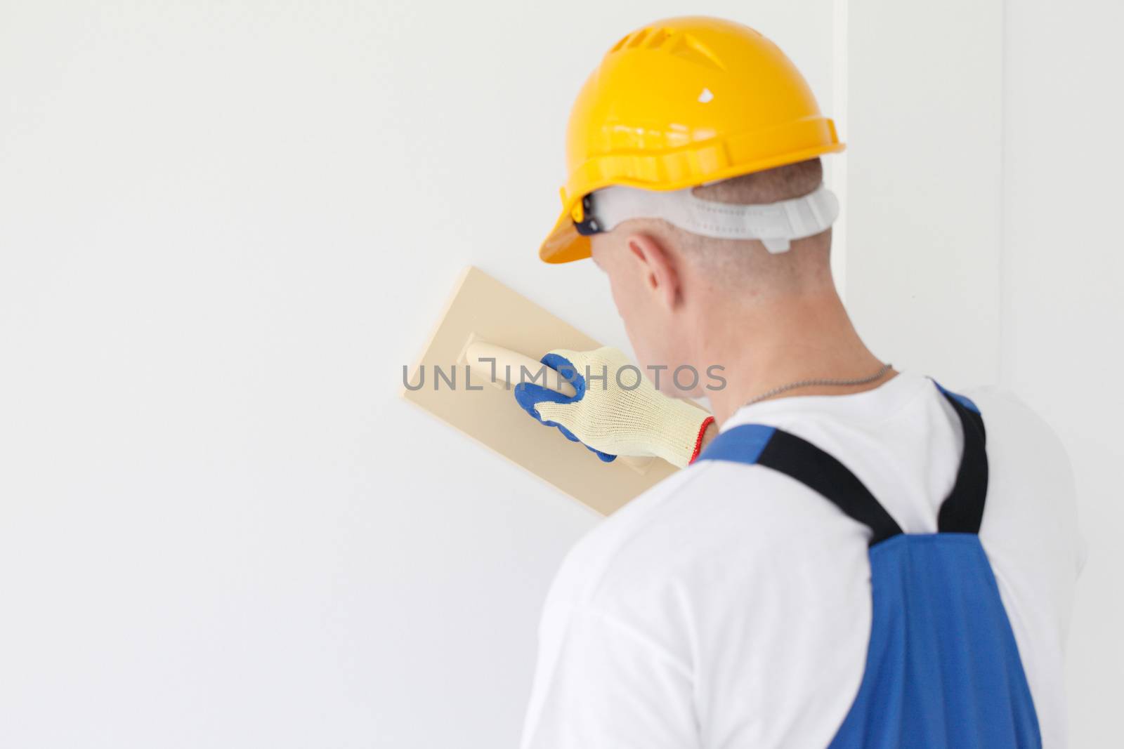 Worker aligns with sandpaper finishing surface