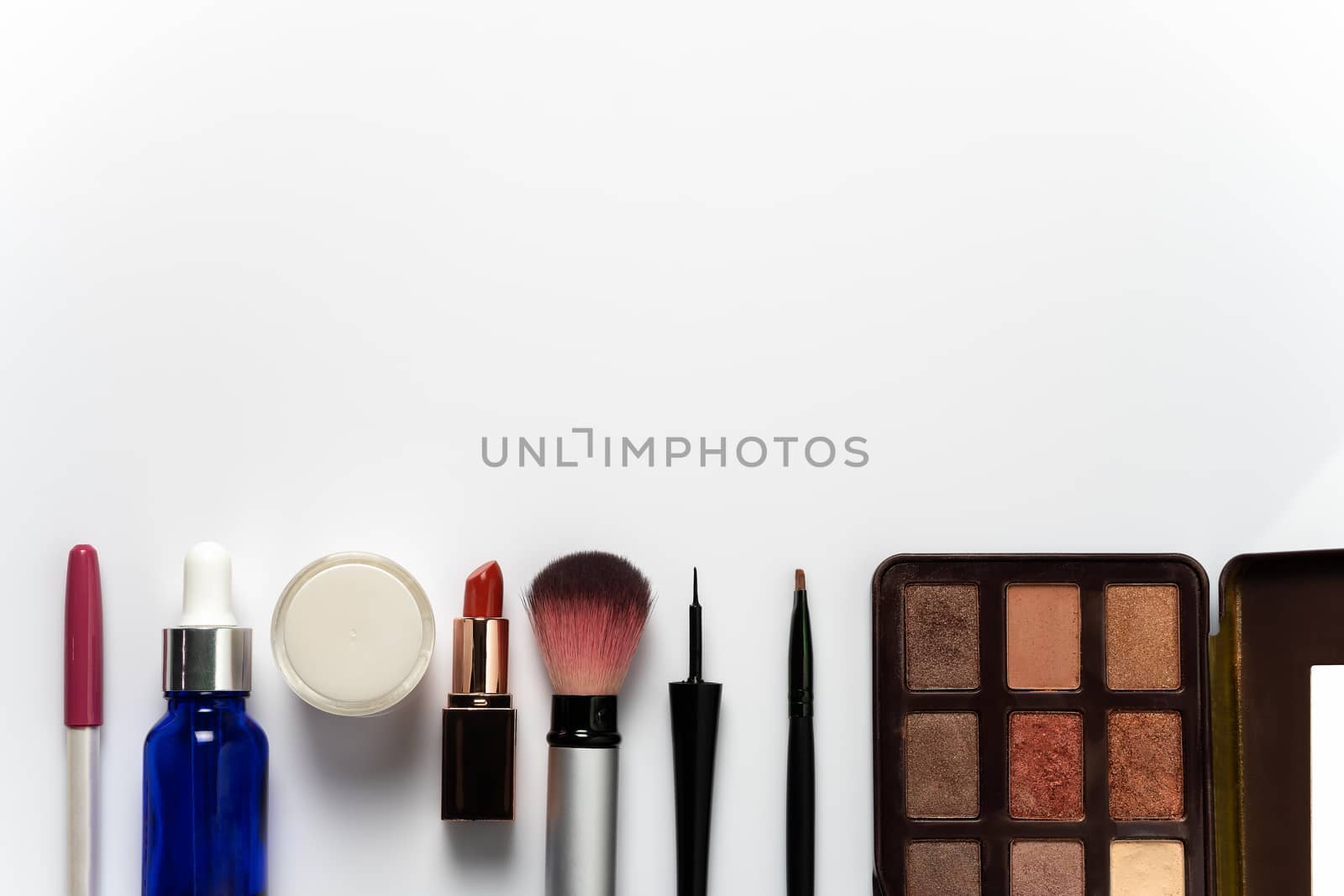 Many cosmetics for makeup and beauty of women on white background. Copy space for text or articles about beauty.