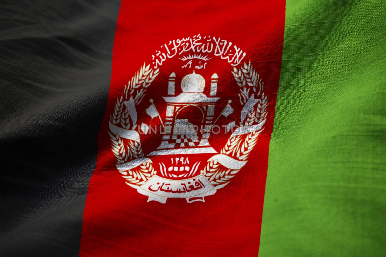 Ruffled Flag of Afghanistan Blowing in Wind