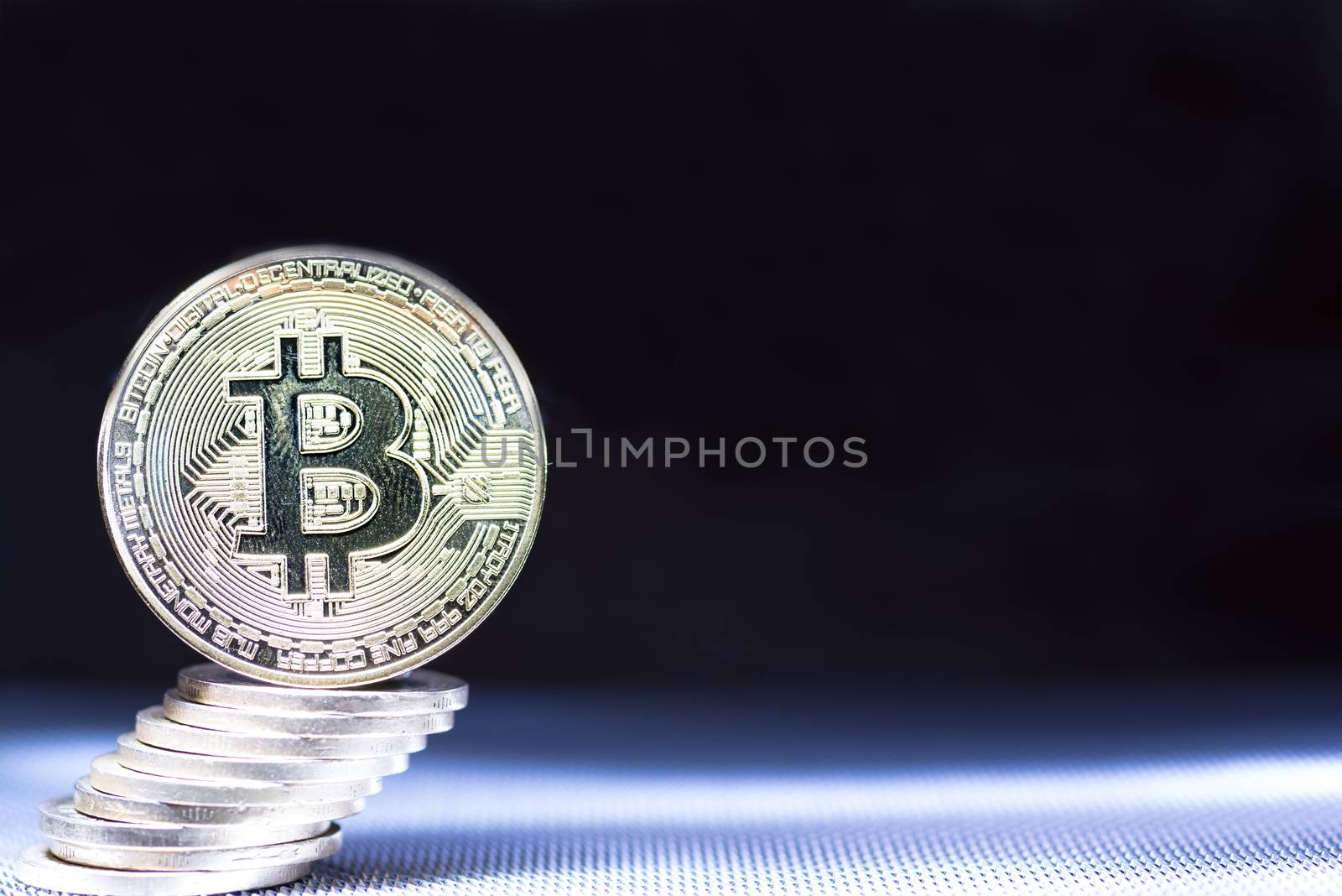 Front view of single golden bit coin with money stack on silver metallic background and surface