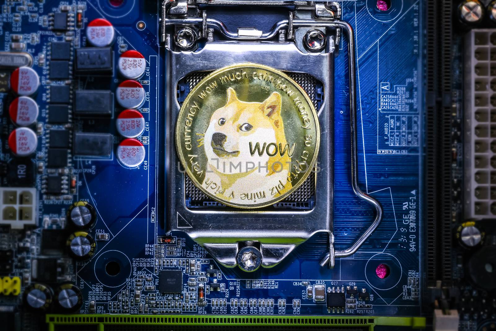 Top view of Dogecoin cryptocurrency physical coin on computer mother board processor.Bitcoin mining farm, working computer equipment concept.