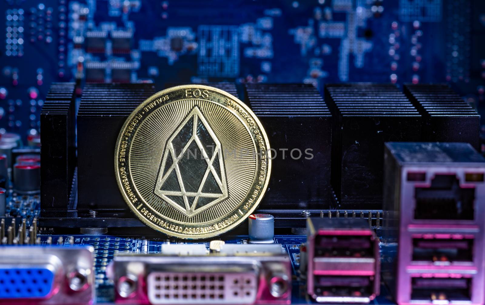 Front view of Eos cryptocurrency over computer video card.Bitcoin mining farm concept.