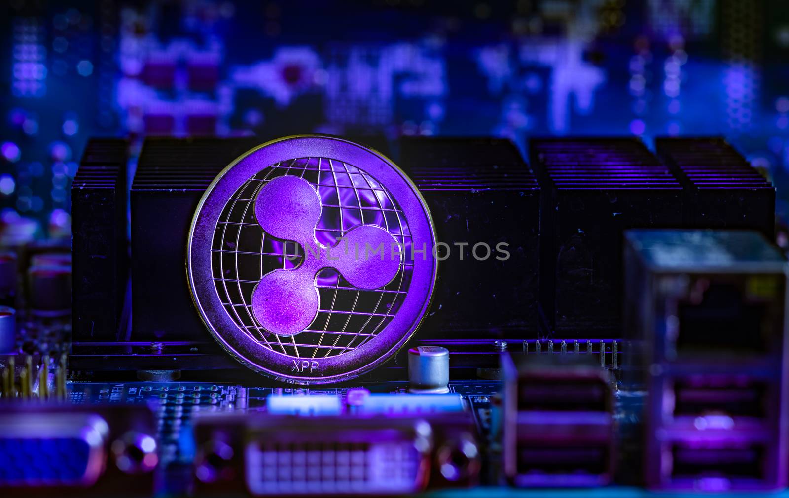 Front view of Ripple(XRP) cryptocurrency over computer video card.Bitcoin mining farm concept.