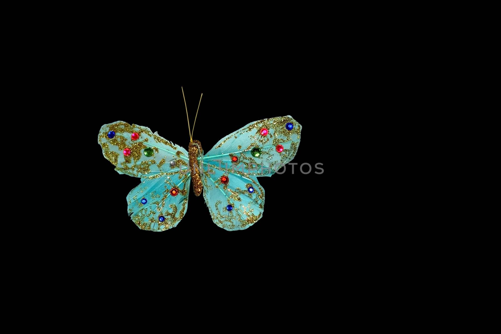 Handmade turquoise butterfly with pink and blue beads isolated on white
