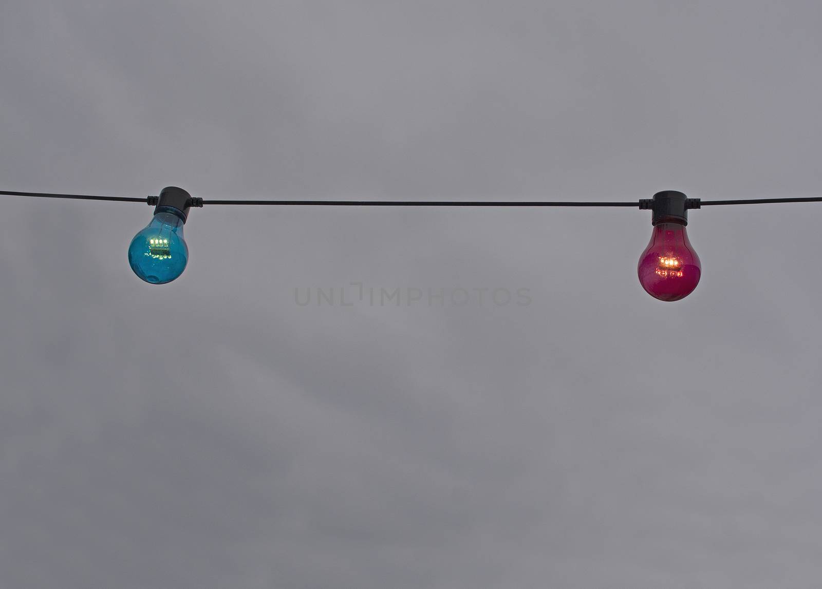Red and blue color lightbulb on string  by ArtesiaWells