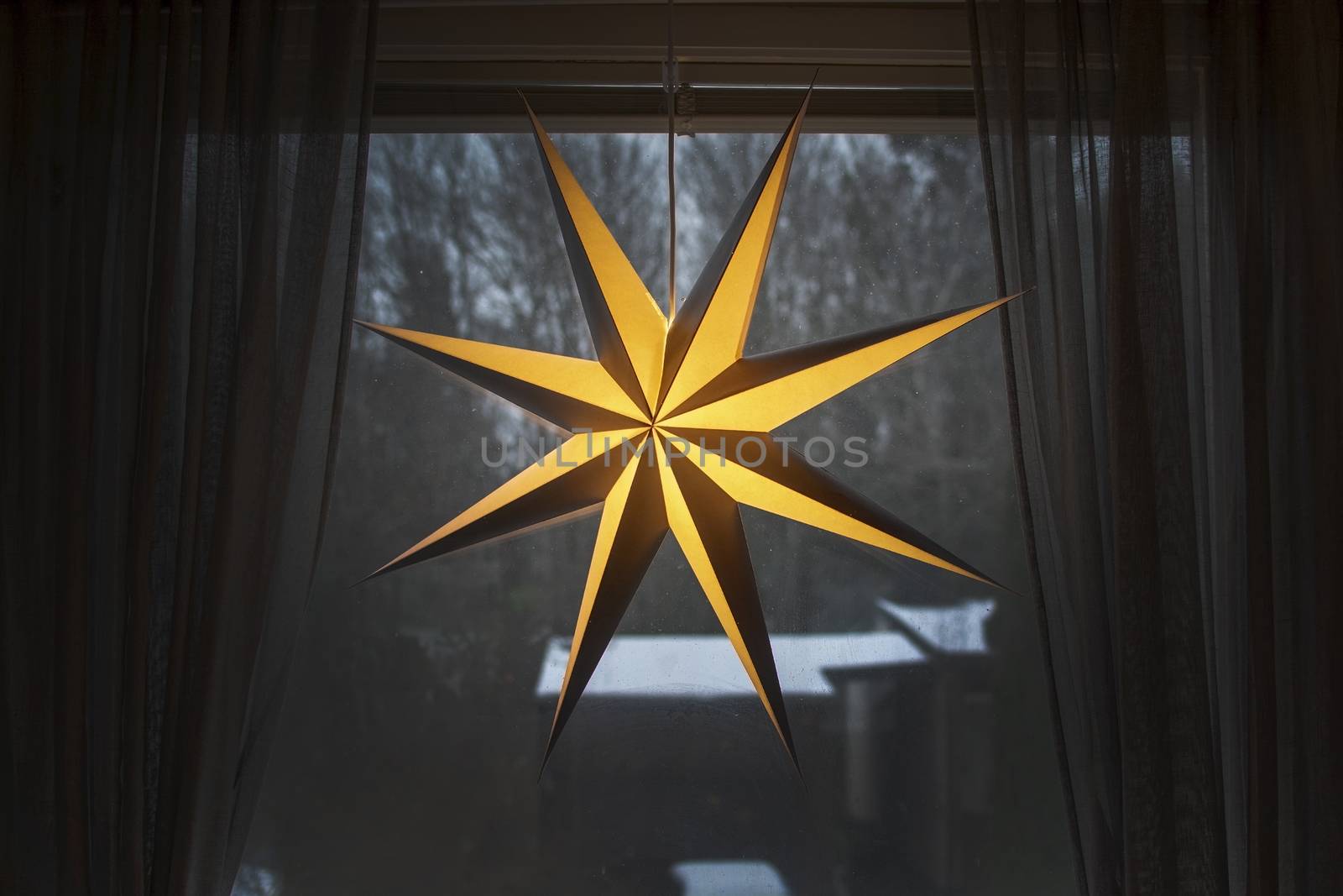 Advent star christmas decorations with snow outside by ArtesiaWells