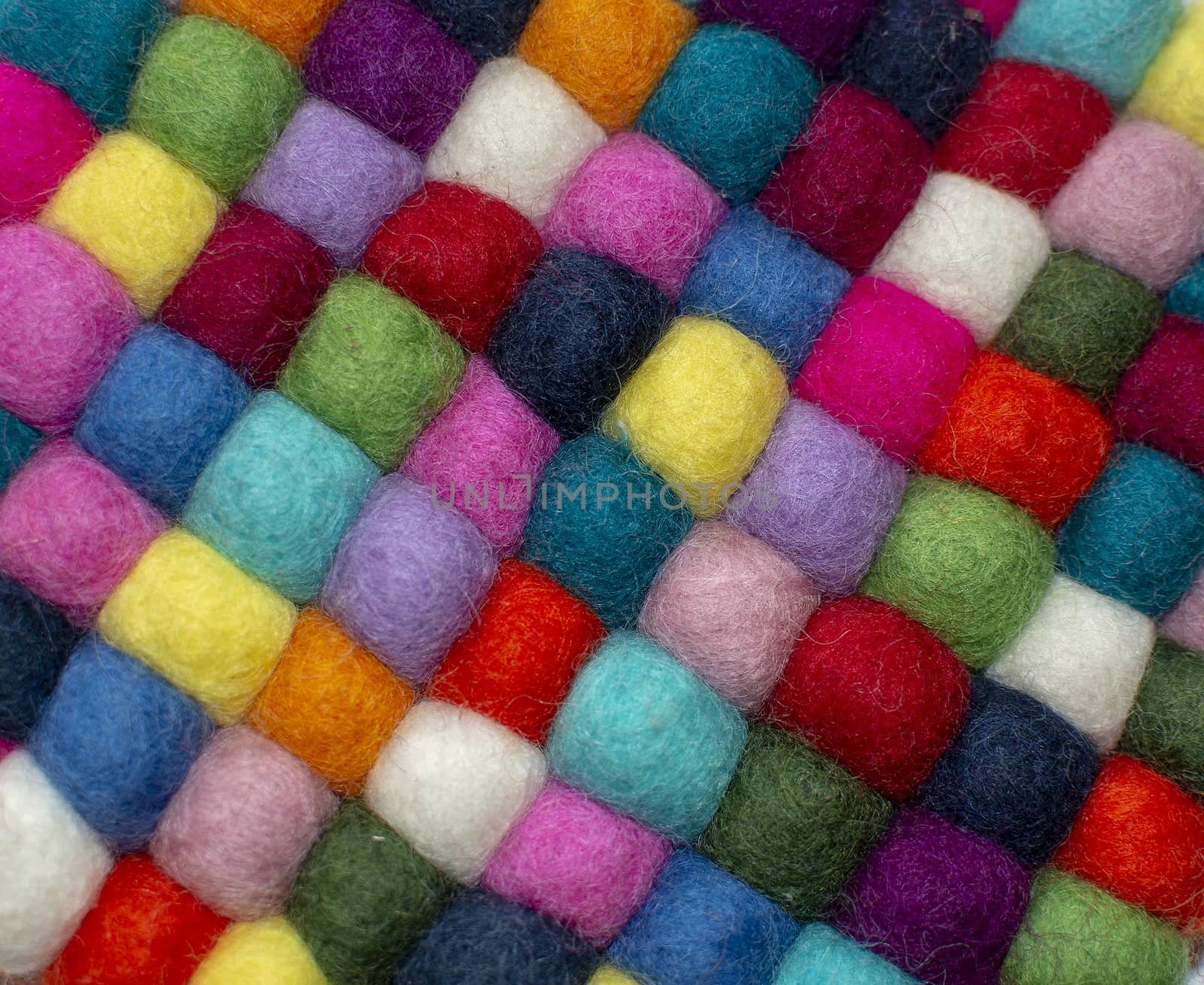 Colorful felted little balls full frame decorative background.