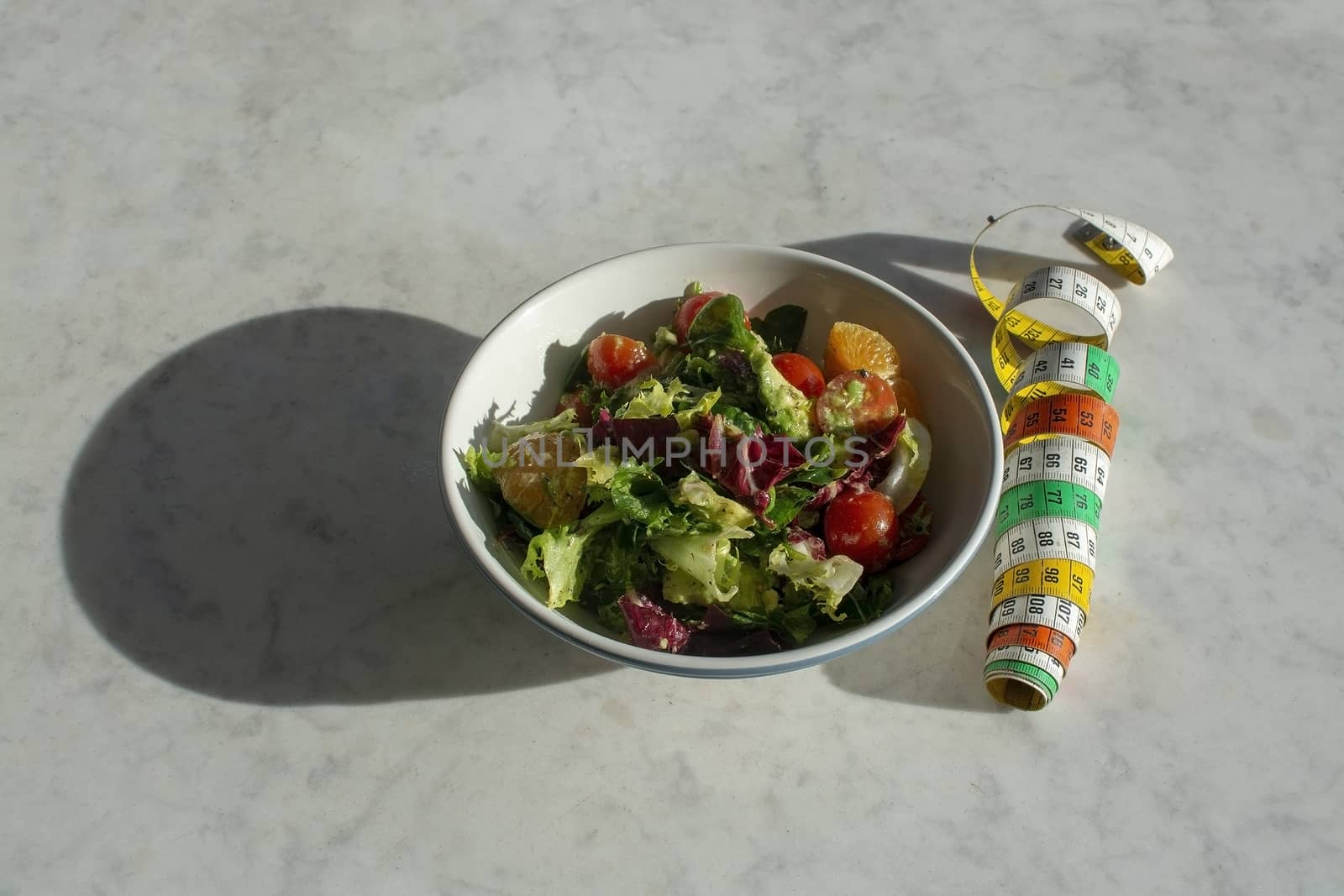 Mixed green and purple salad with measuring tape by ArtesiaWells