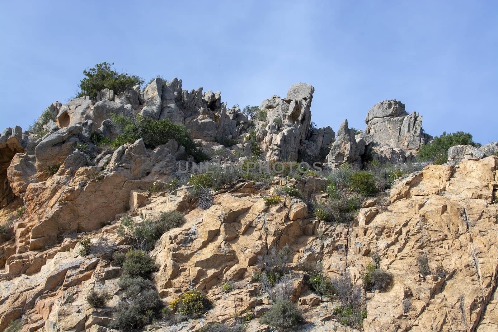 Granite rock shapes against blue sky in Costa Smeralda, Sardinia, Italy.