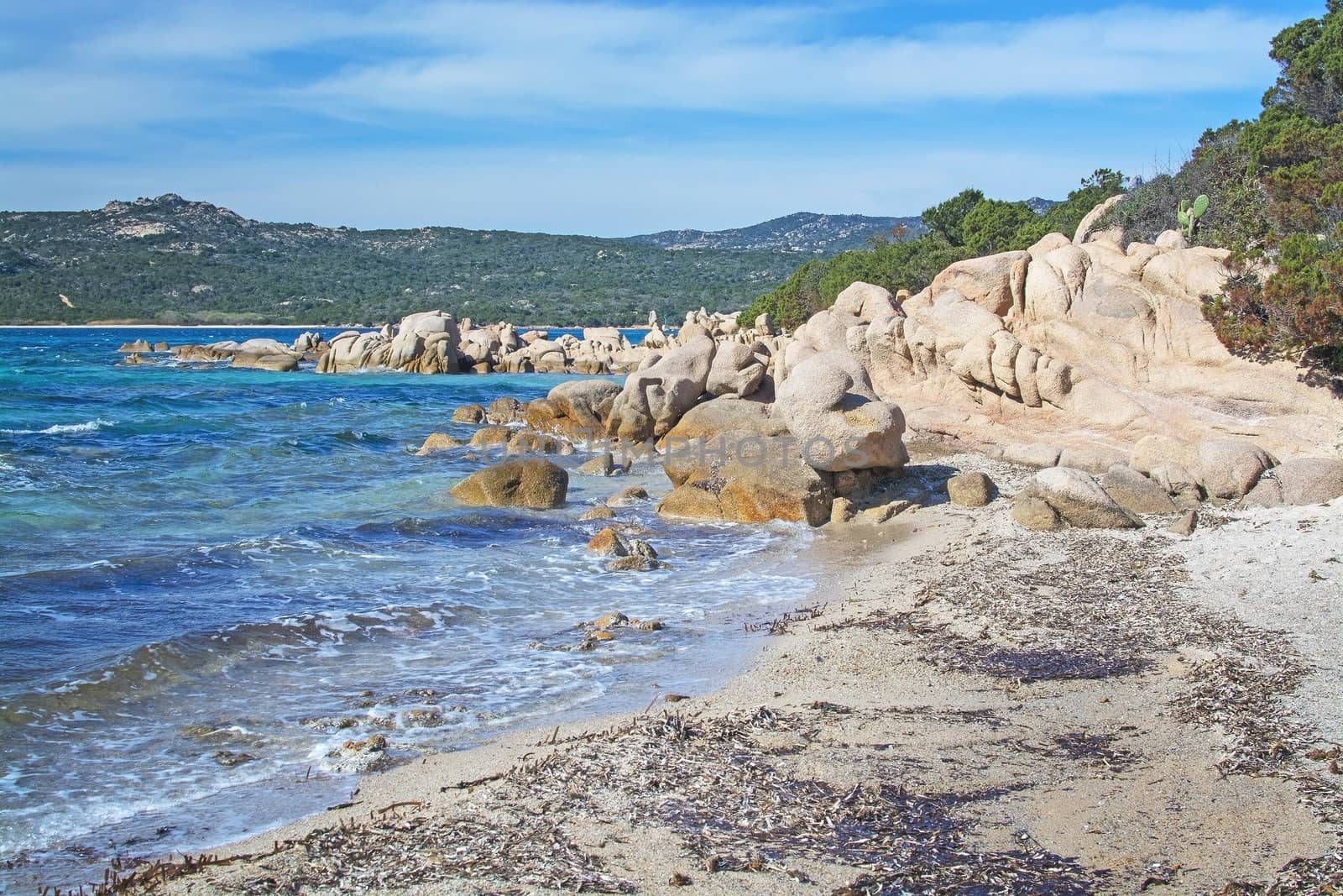 Green water and funny granite rock shapes on a beach in Costa Smeralda, Sardinia, Italy in March.