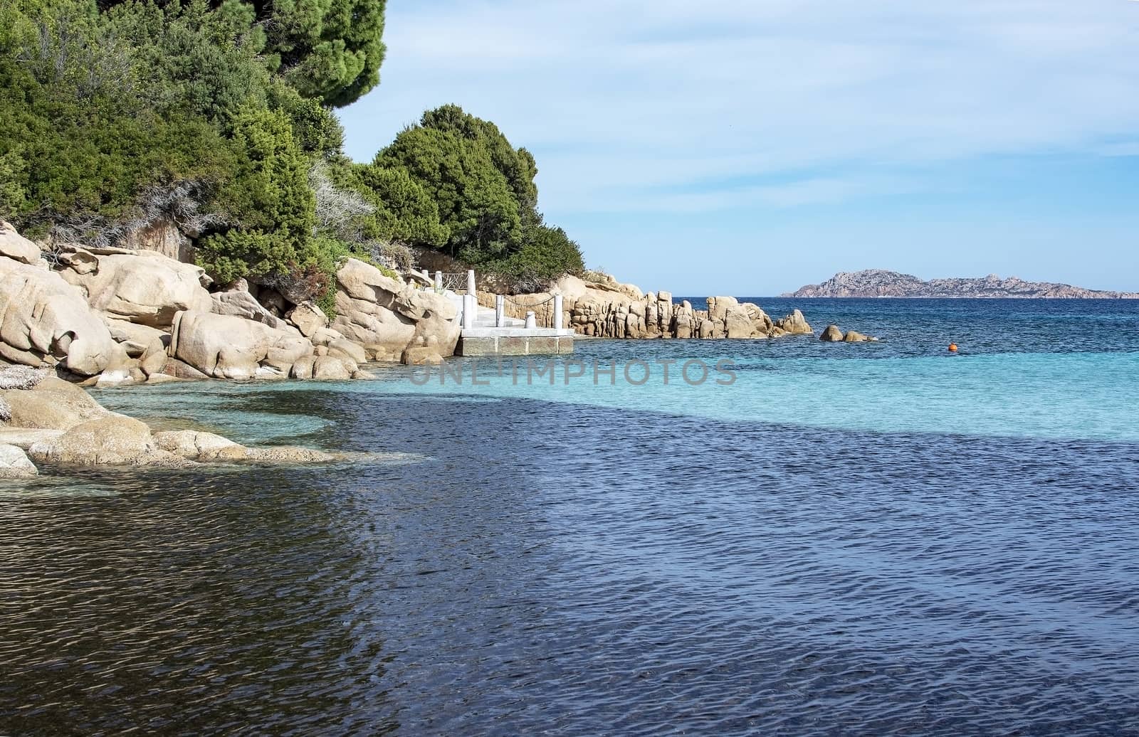 Green water and funny granite rock shapes on a beach in Costa Smeralda, Sardinia, Italy in March.