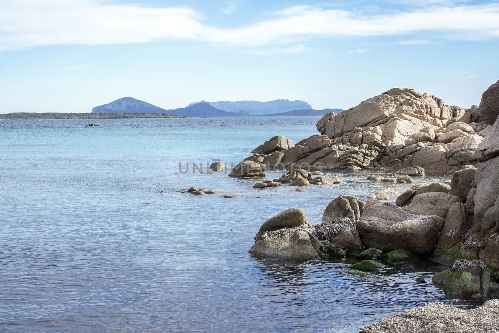 Green water and granite rock archipelago landscape on a beach in Costa Smeralda, Sardinia, Italy in March.