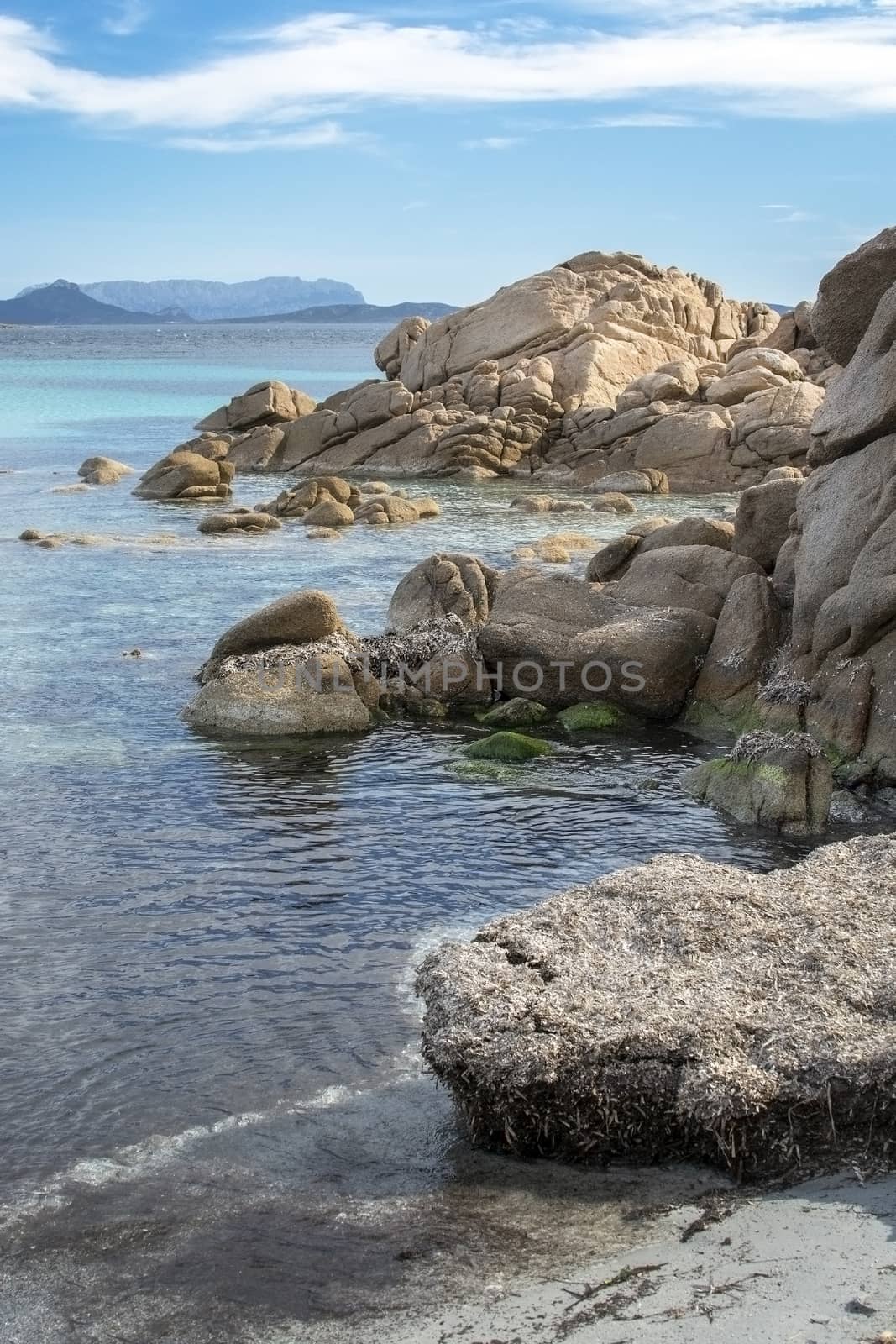 Green water and granite boulders on a beach in Costa Smeralda Sa by ArtesiaWells