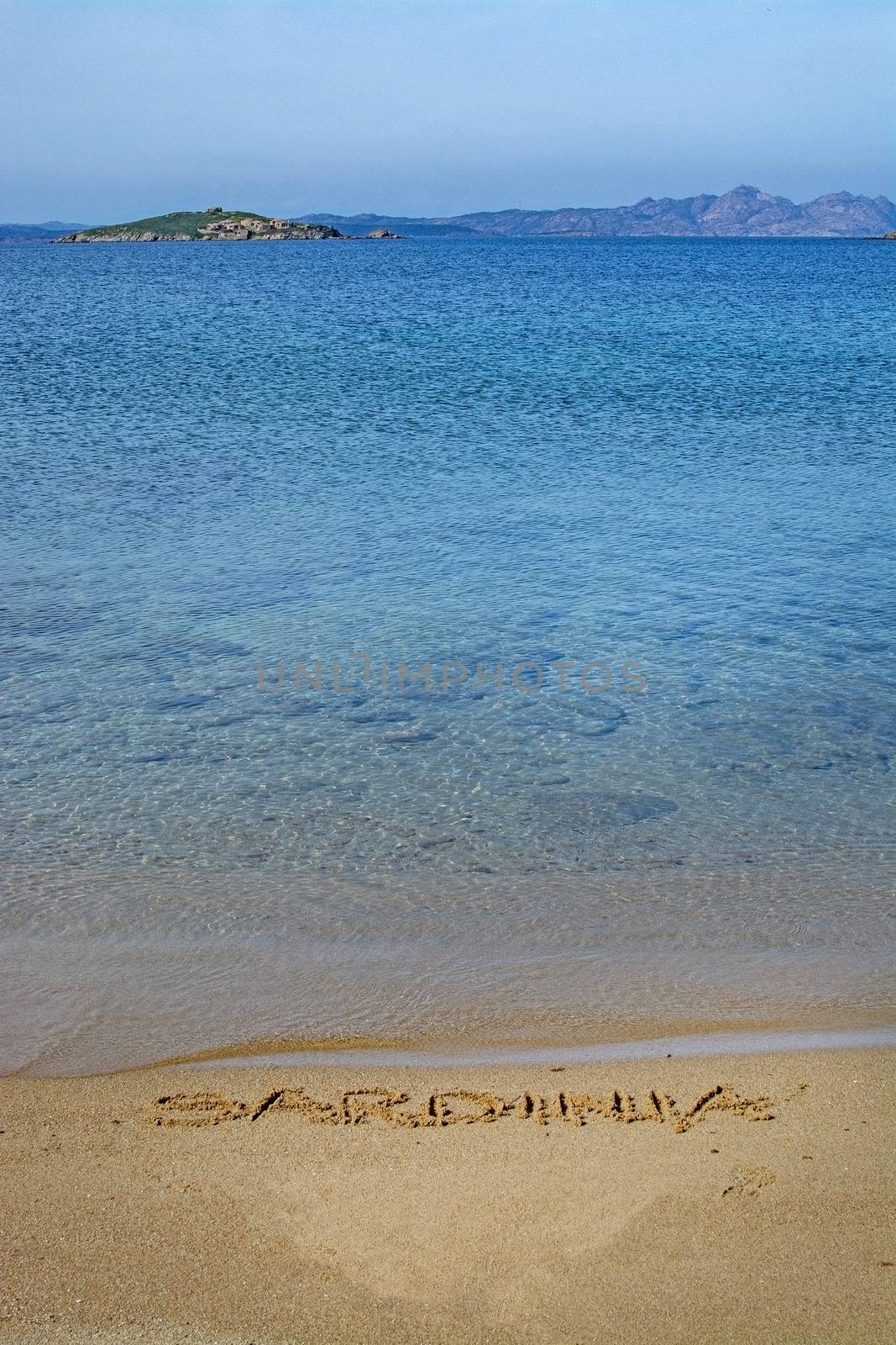 Sardinia word written in sand on a beach by ArtesiaWells