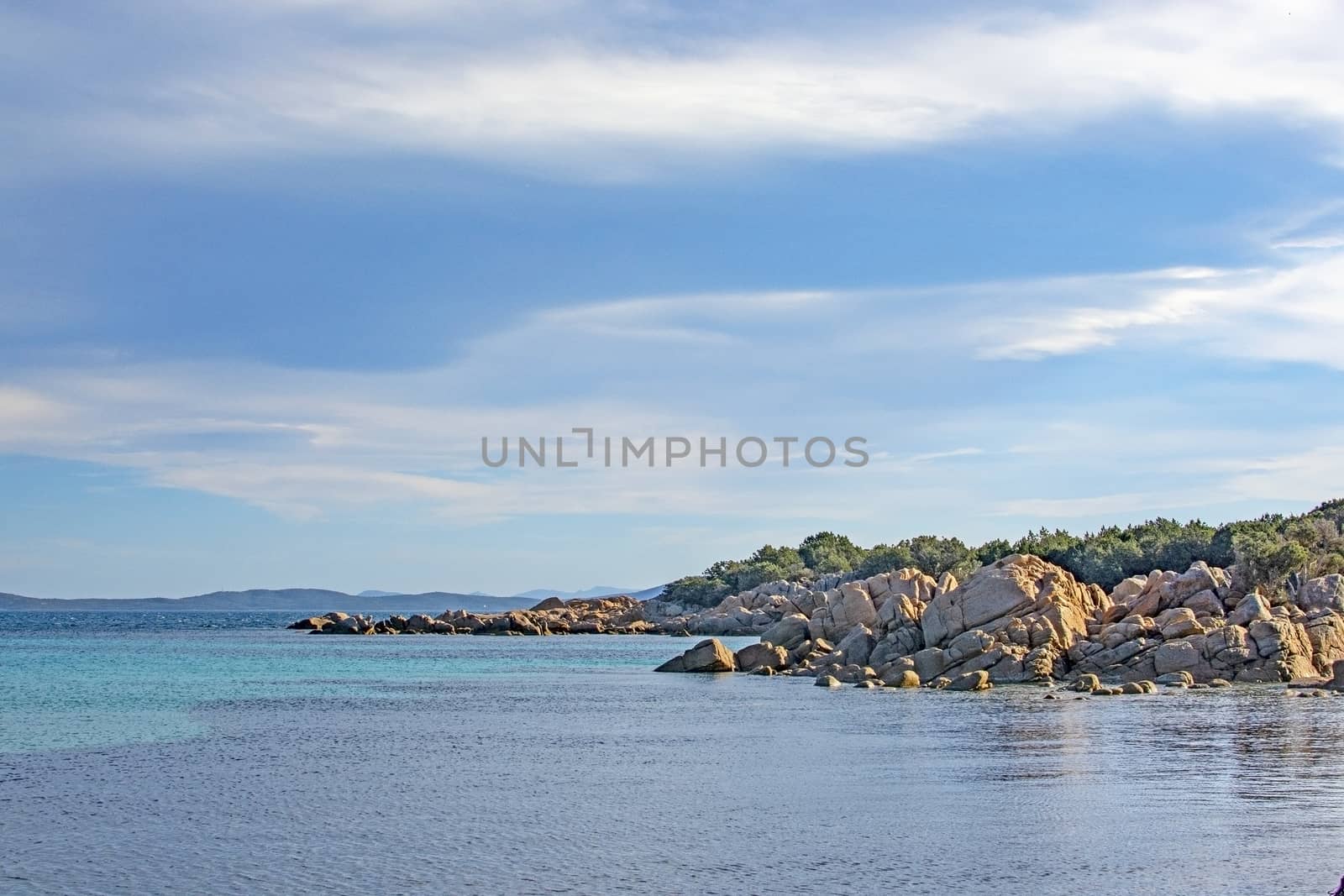 Seascape from a winter beach and blue and green sea in Costa Smeralda, Sardinia, Italy in March.