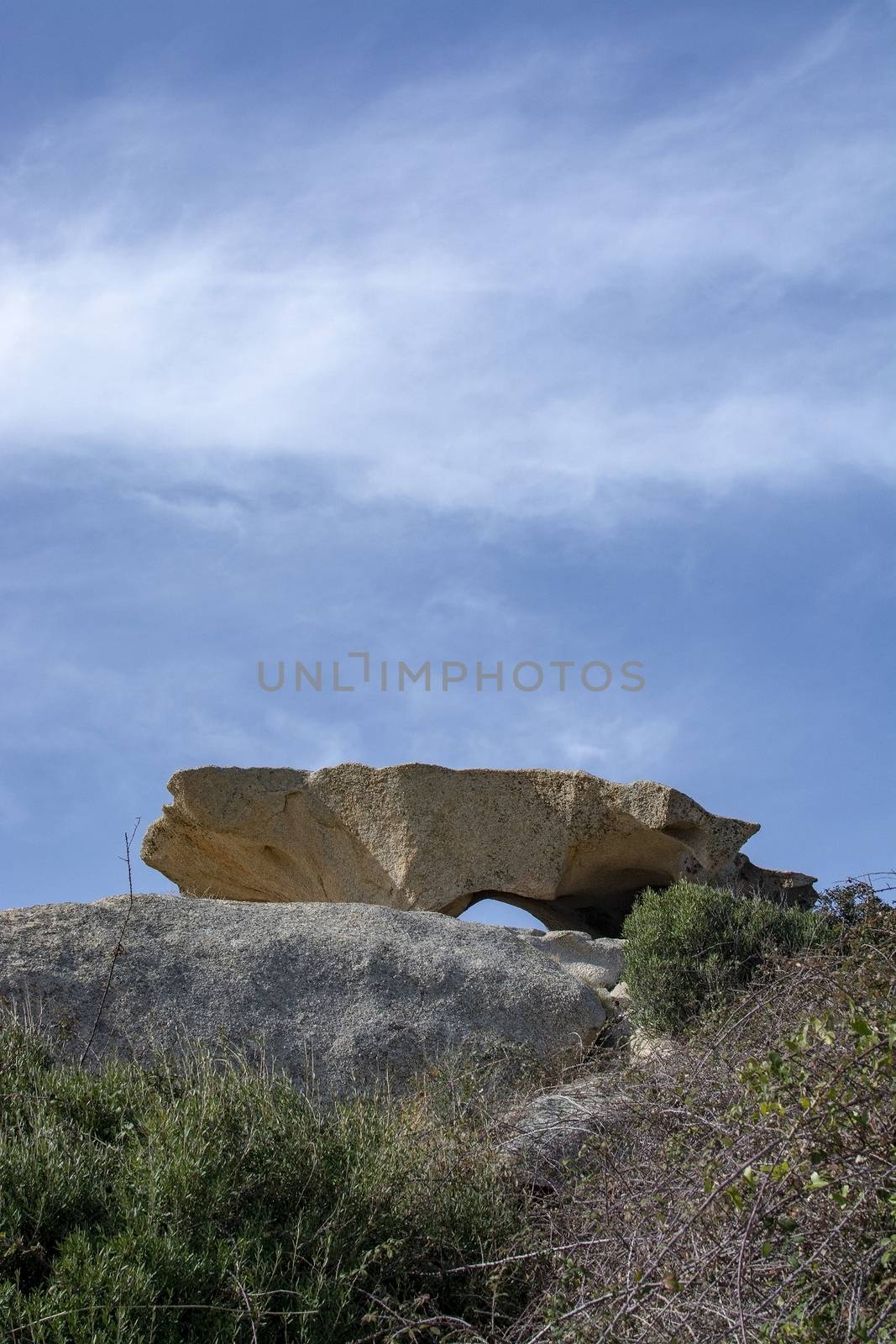 Slab of granite rock lying on top of eroded cliff by ArtesiaWells