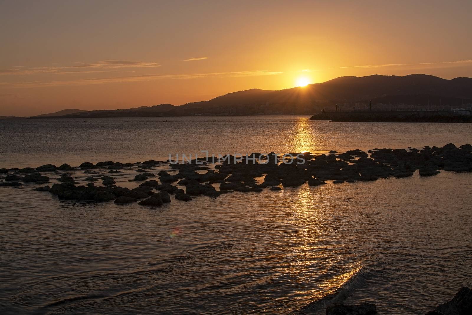 Beautiful golden sunset over mountains and ocean by ArtesiaWells