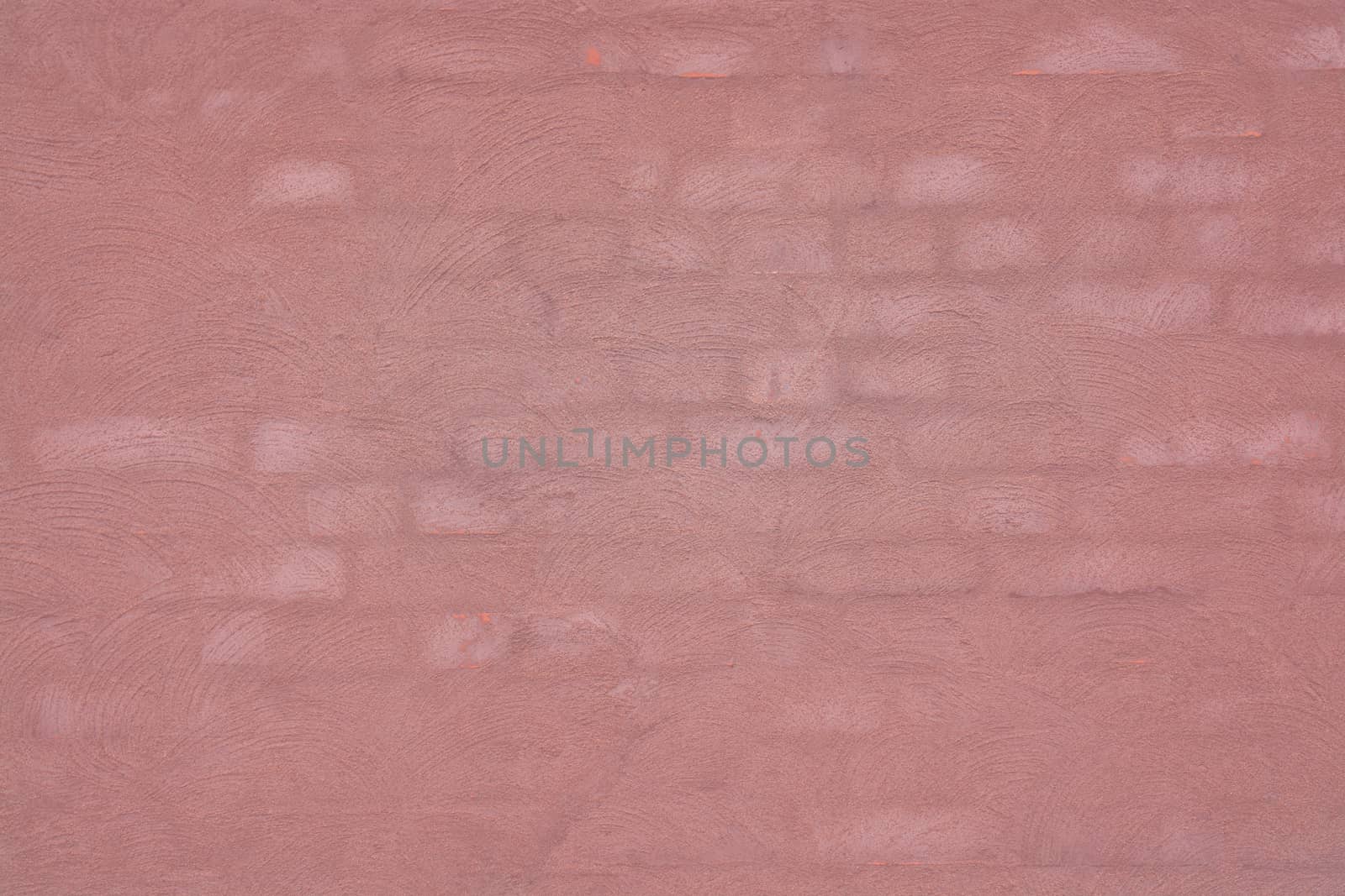 Washed brick wall background texture toned in Living Coral color