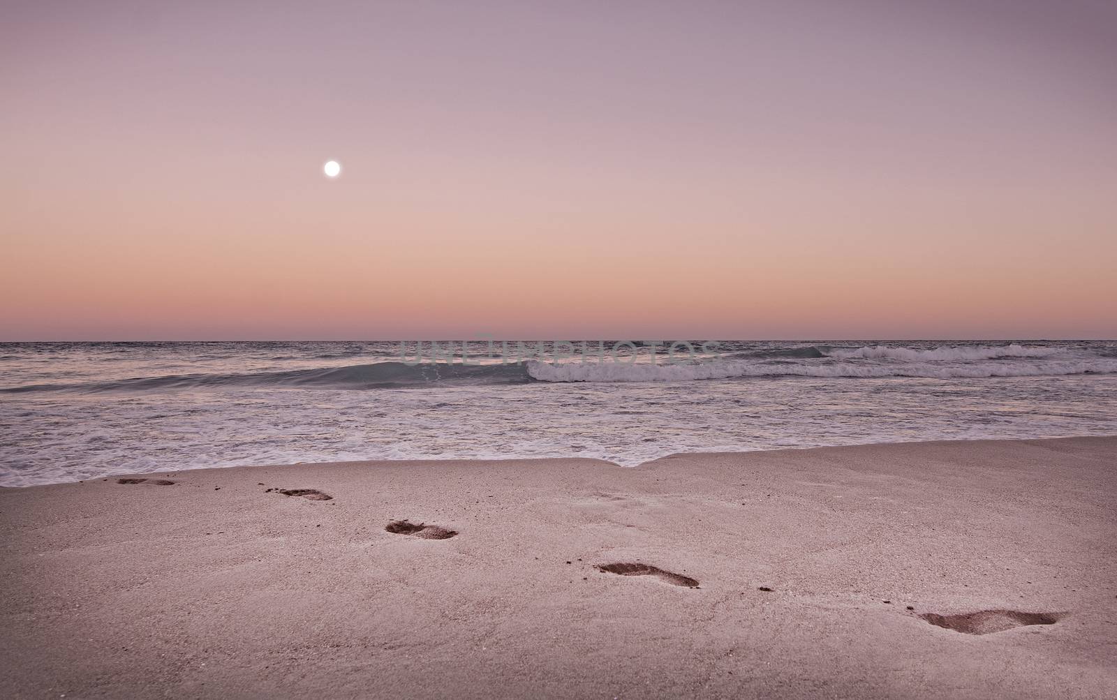 Beach footprints in orange dusk toned in Living Coral by ArtesiaWells